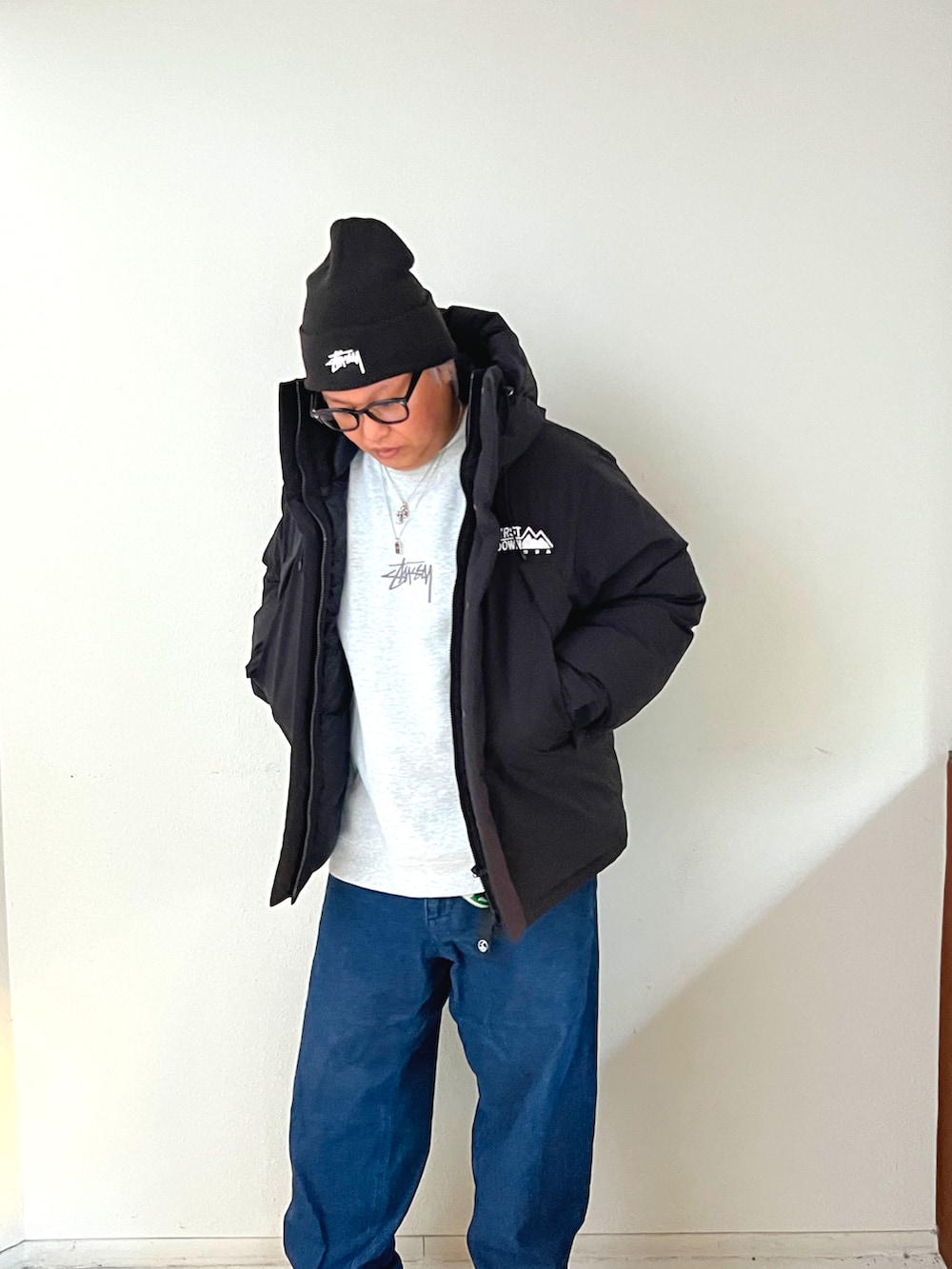 ブラック系のダウンジャケット/コート、グレー系のその他トップス、ブルー系のデニムパンツを着用したメンズの冬コーディネートの2枚目の写真