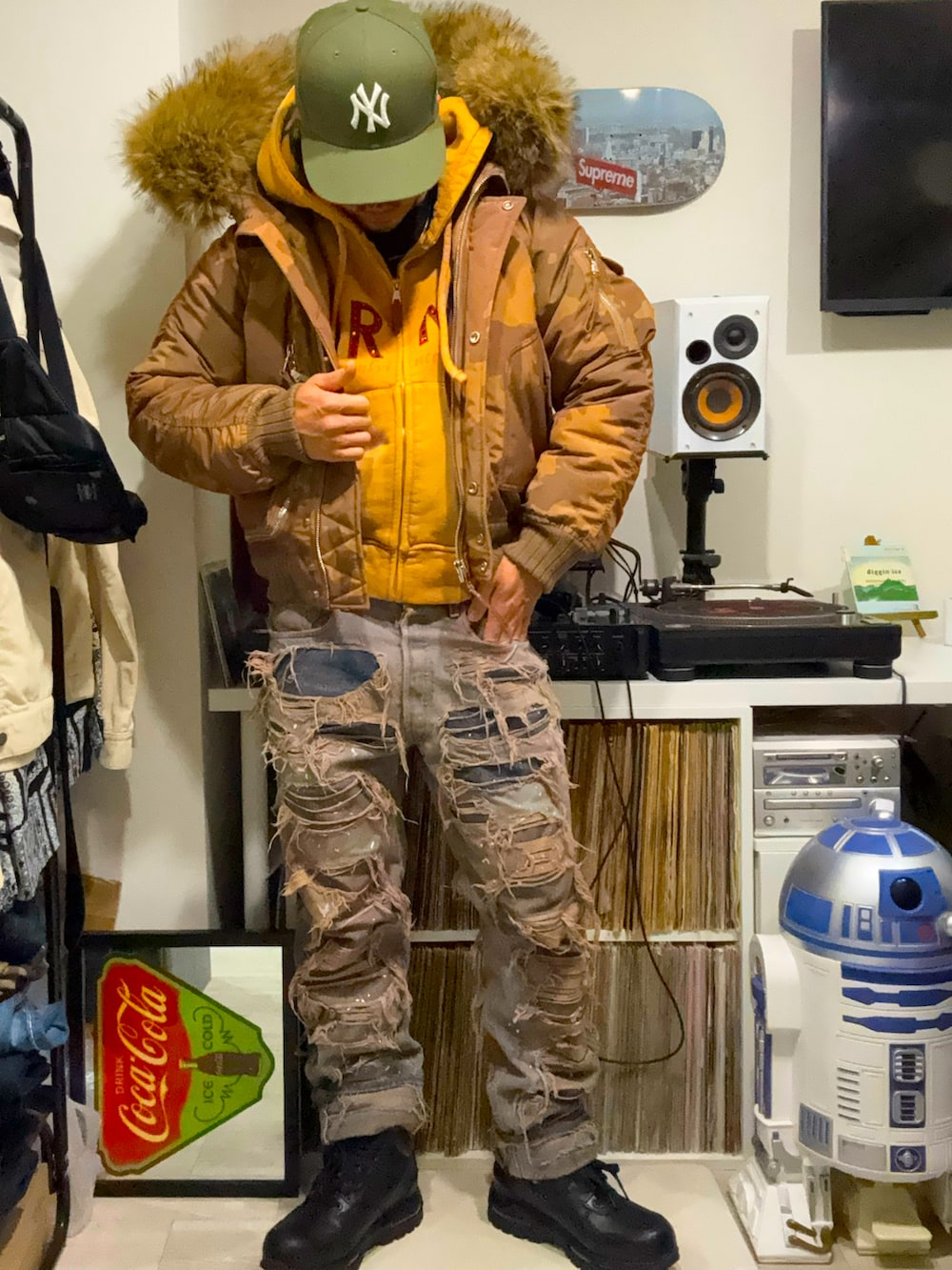 ベージュ系のダウンジャケット/コート、ベージュ系のパーカー、ブルー系のデニムパンツを着用したメンズの春コーディネートの2枚目の写真