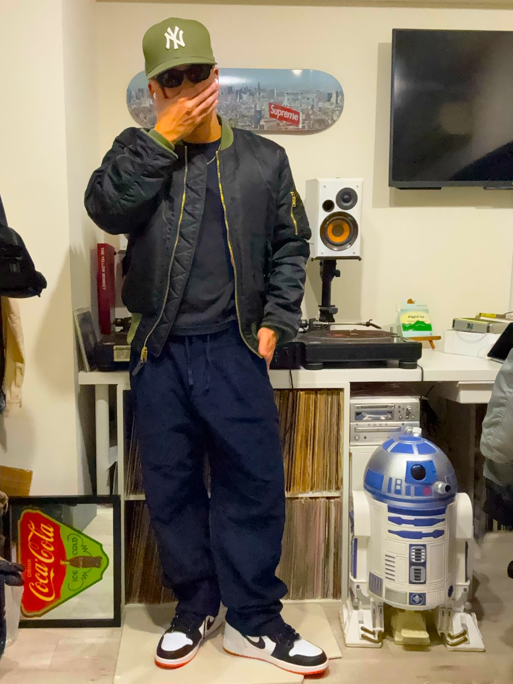 ブラック系のMA-1、ブラック系のチノパンツ、オレンジ系のスニーカーを着用したメンズの春コーディネートの2枚目の写真