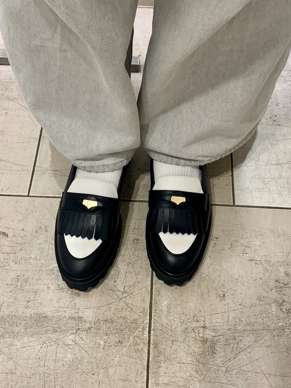 ブラック系のローファーを着用したレディースの春コーディネートの2枚目の写真