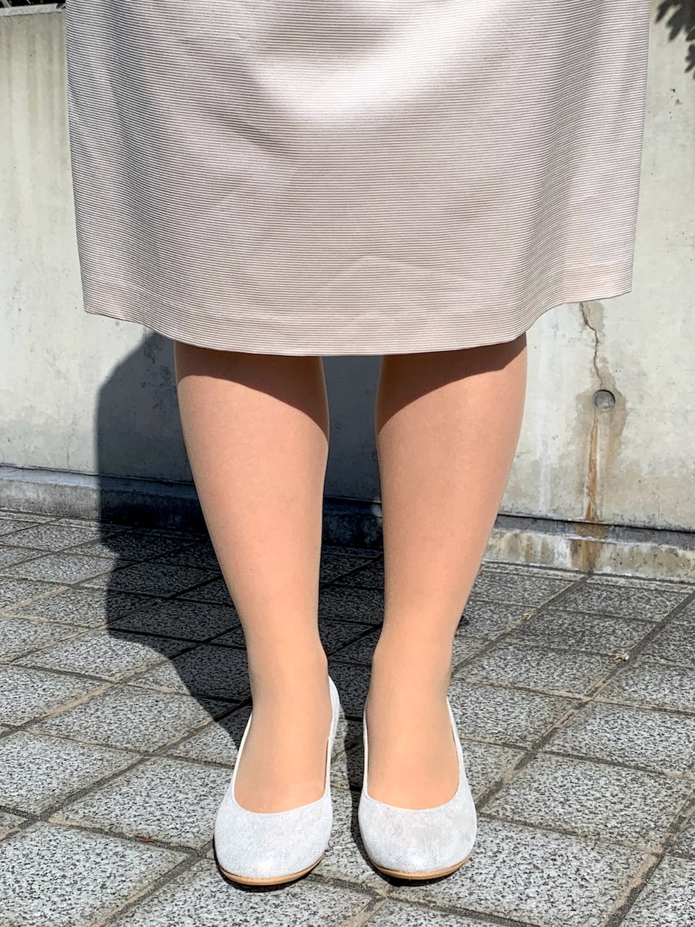 シルバー系のパンプスを着用したレディースの冬コーディネートの2枚目の写真