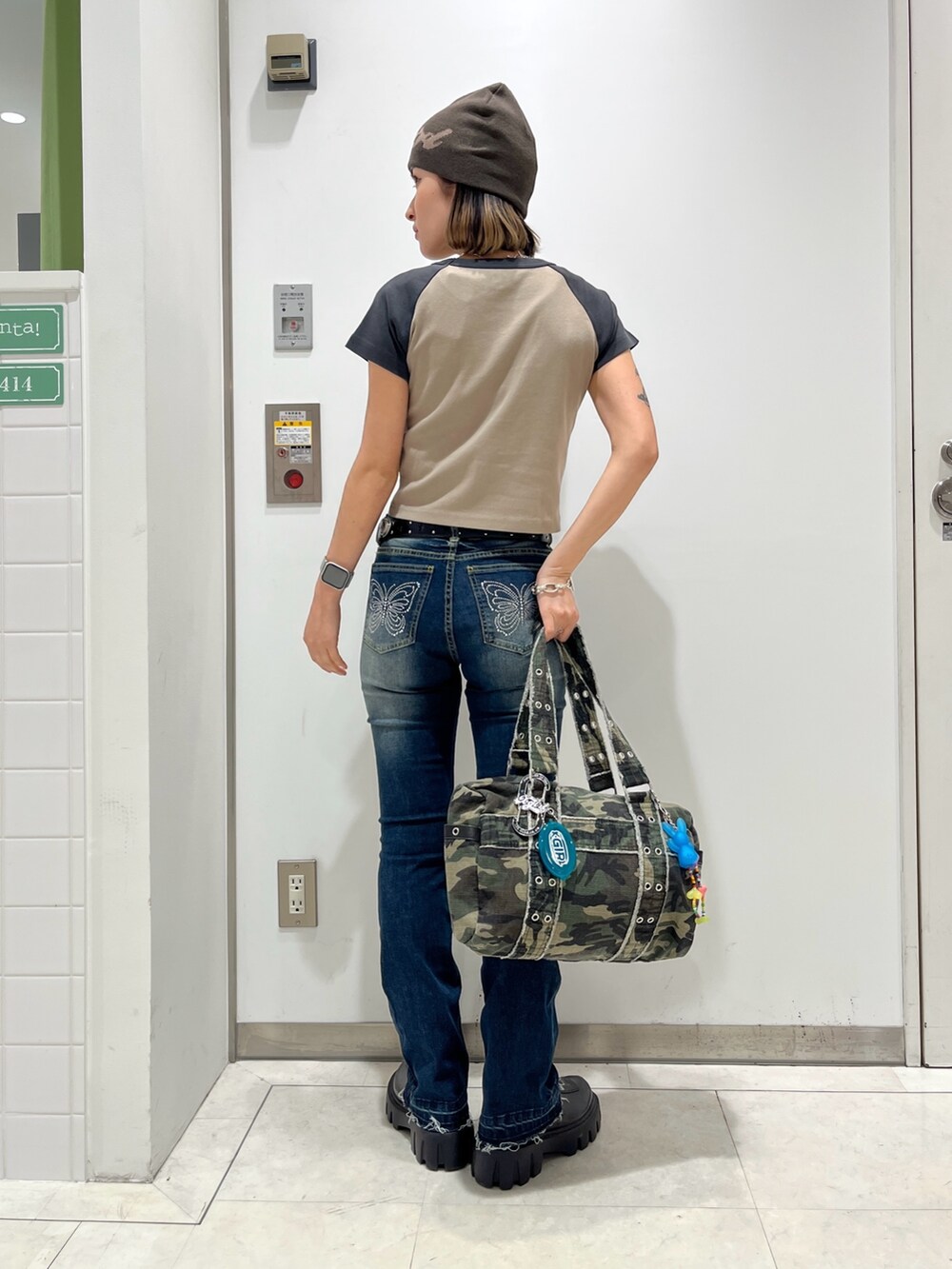 ベージュ系のTシャツ/カットソー、ブルー系のデニムパンツ、その他のハンドバッグを着用したレディースの春コーディネートの2枚目の写真