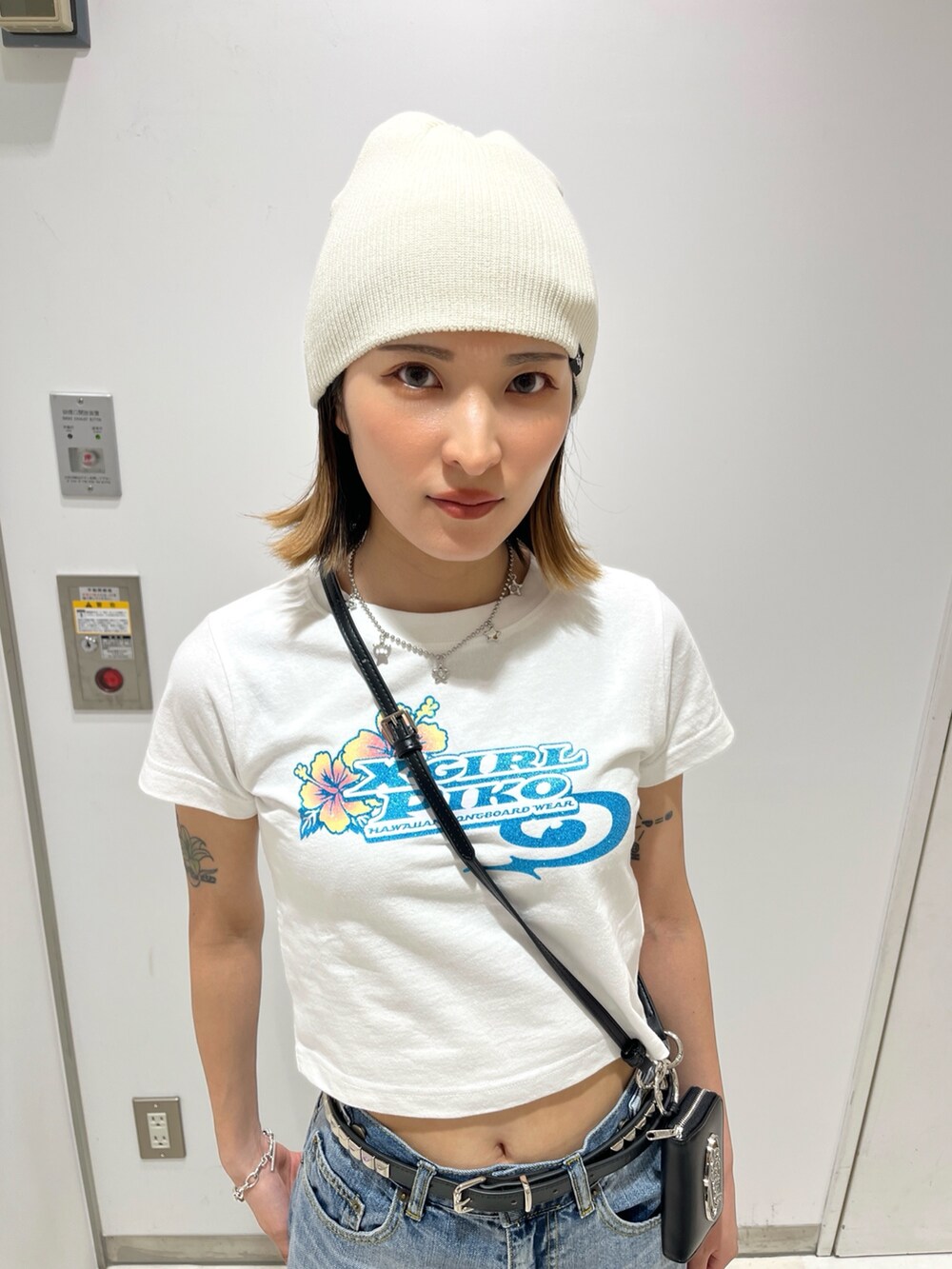 ブルー系のデニムパンツ、ホワイト系のTシャツ/カットソー、ホワイト系のニットキャップ/ビーニーを着用したレディースの夏コーディネートの5枚目の写真