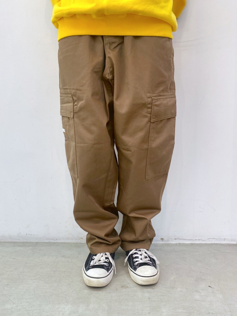 イエロー系のスウェット、ベージュ系のその他パンツを着用したレディースの春コーディネートの4枚目の写真