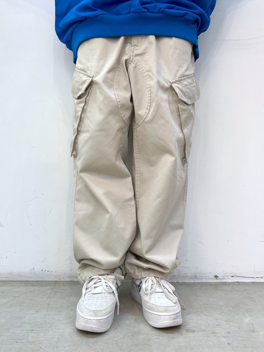 ブルー系のTシャツ/カットソー、ベージュ系のその他パンツ、ブラック系のキャップを着用したレディースの春コーディネートの4枚目の写真