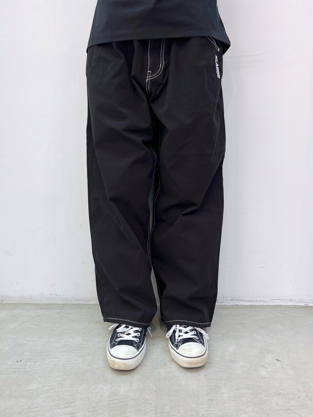 ブラック系のTシャツ/カットソー、ブラック系のその他パンツ、ホワイト系のキャップを着用したレディースの春コーディネートの4枚目の写真