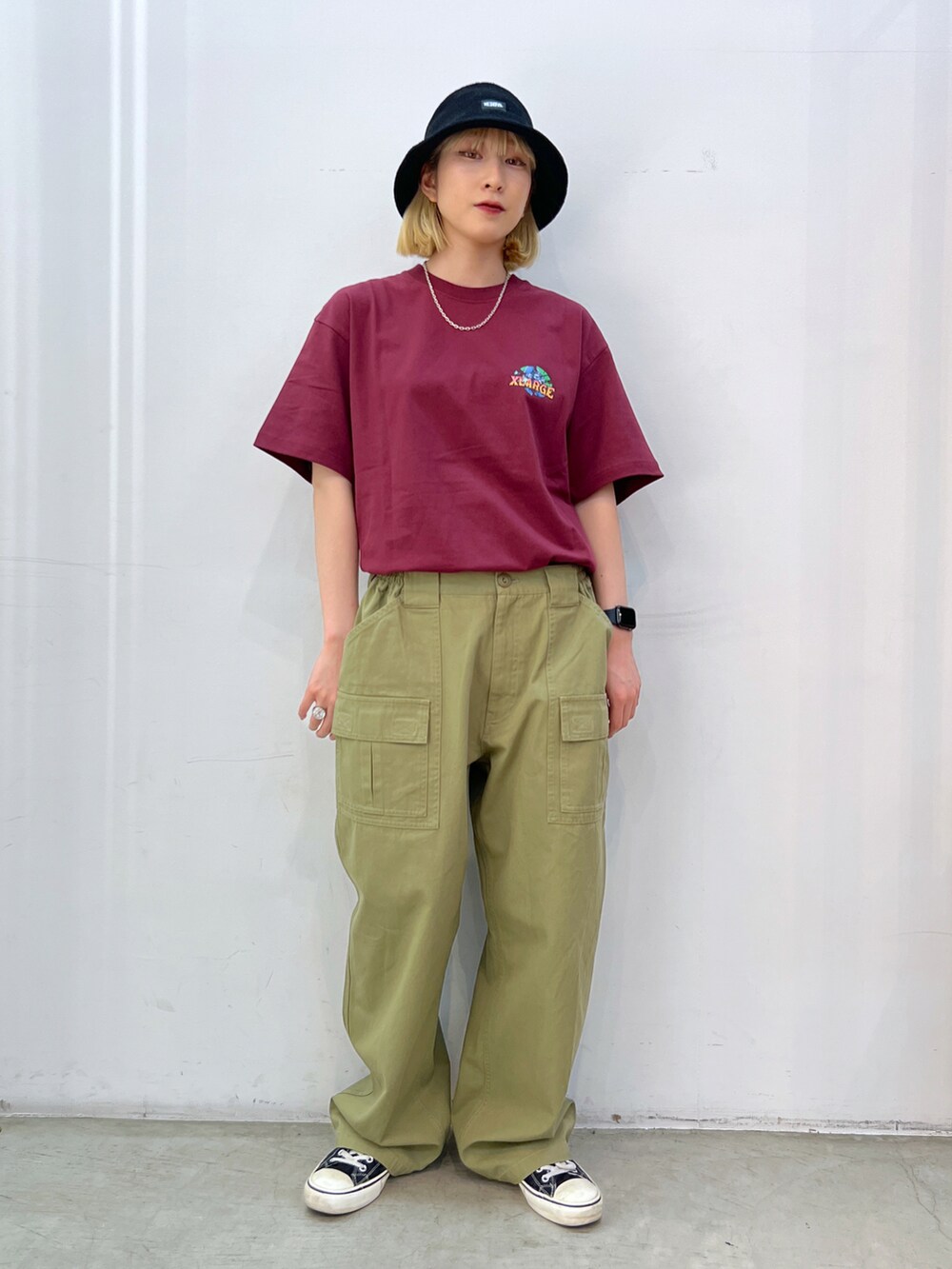 レッド系のTシャツ/カットソー、グレー系のその他パンツ、ブラック系のハットを着用したレディースの夏コーディネートの3枚目の写真