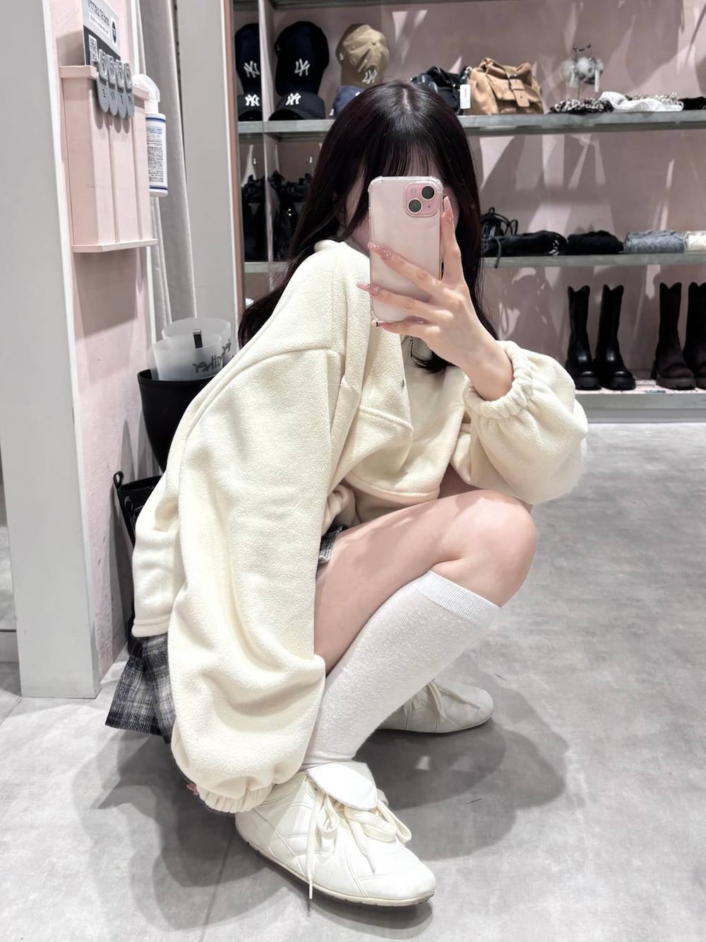 ホワイト系のスニーカー、ブラック系のスカート、ホワイト系のスウェットを着用したレディースの冬コーディネートの8枚目の写真