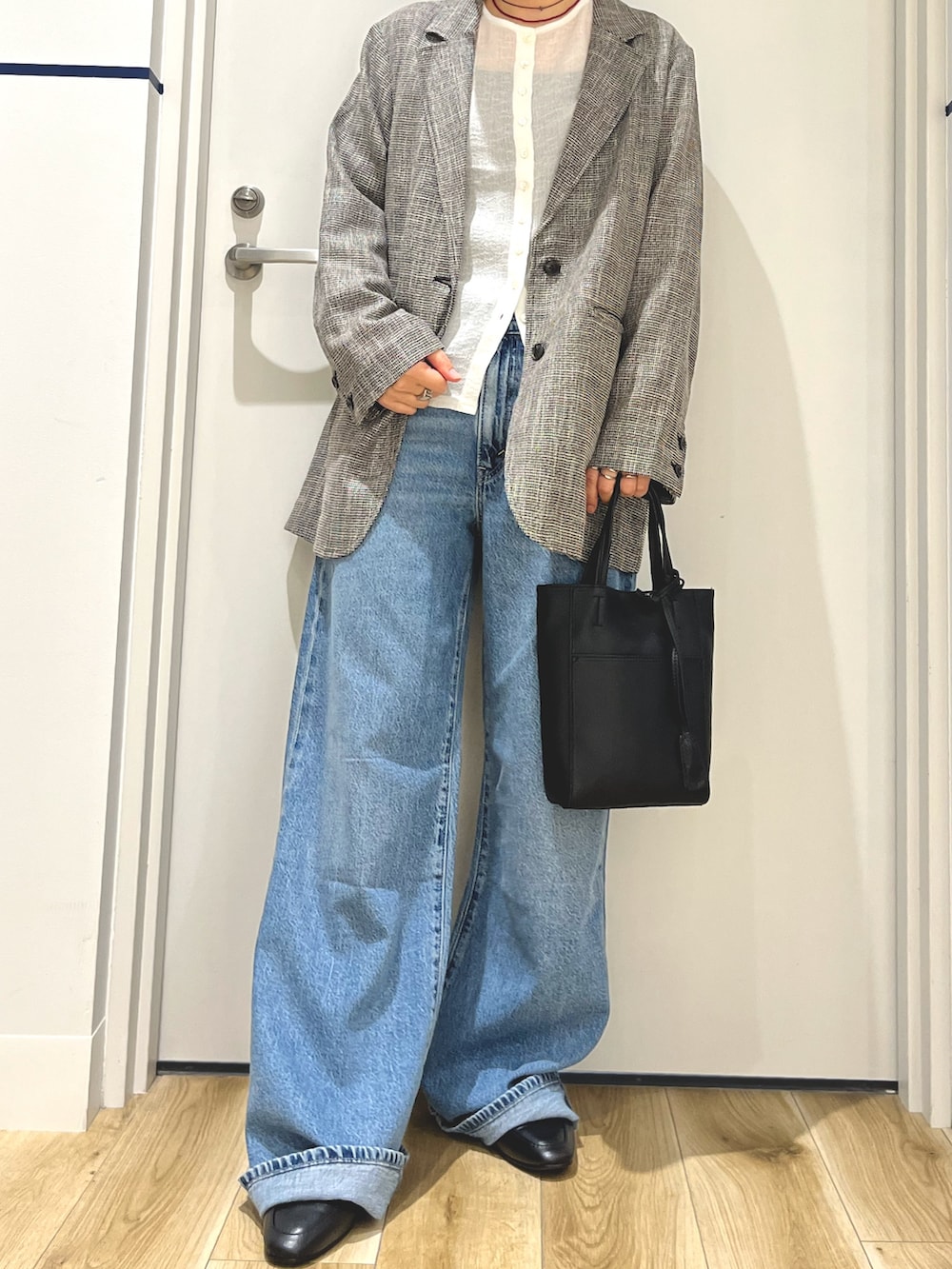 グレー系のその他アウター、ブルー系のデニムパンツ、ブラック系のトートバッグを着用したレディースの秋コーディネートの4枚目の写真