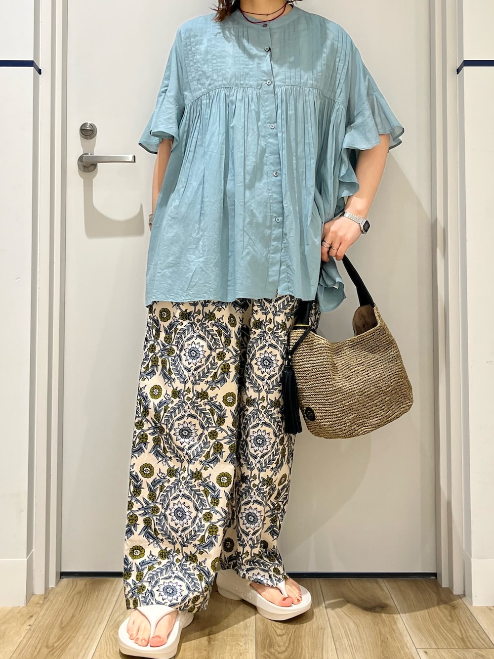 ブルー系のシャツ/ブラウス、ベージュ系のその他パンツ、ブラウン系のかごバッグを着用したレディースの春コーディネートの6枚目の写真