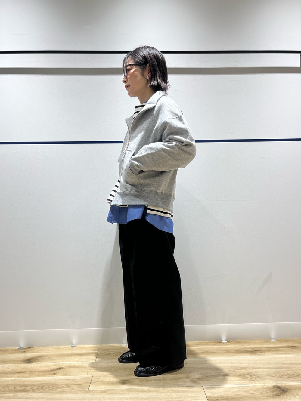 ブラック系のその他パンツ、ブラック系のローファー、ブルー系のシャツ/ブラウスを着用したレディースの冬コーディネートの2枚目の写真