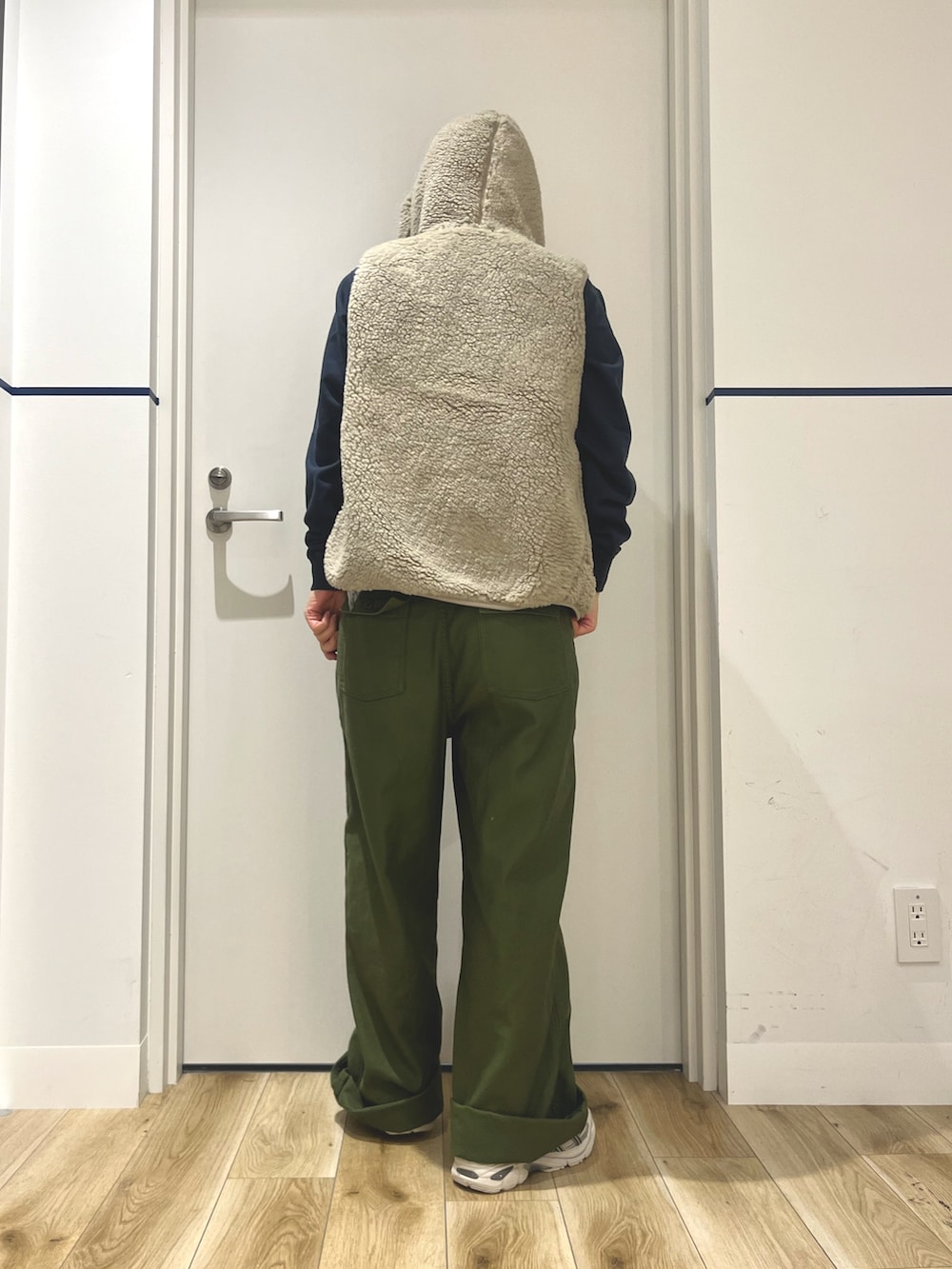 グレー系のスニーカー、グリーン系のその他パンツ、ベージュ系のベストを着用したレディースの秋コーディネートの2枚目の写真