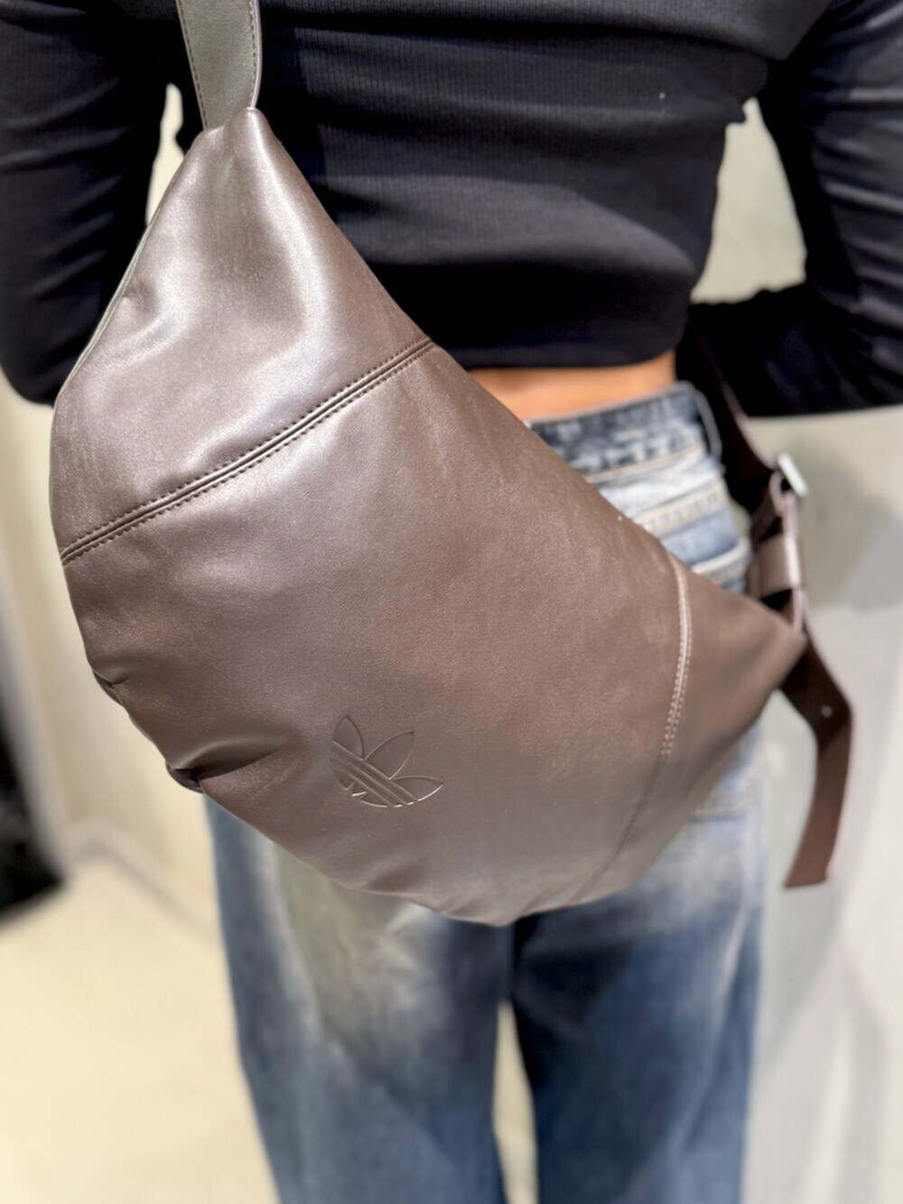 ブラック系のTシャツ/カットソー、グリーン系のスニーカー、ブラウン系のショルダーバッグを着用したレディースの冬コーディネートの3枚目の写真