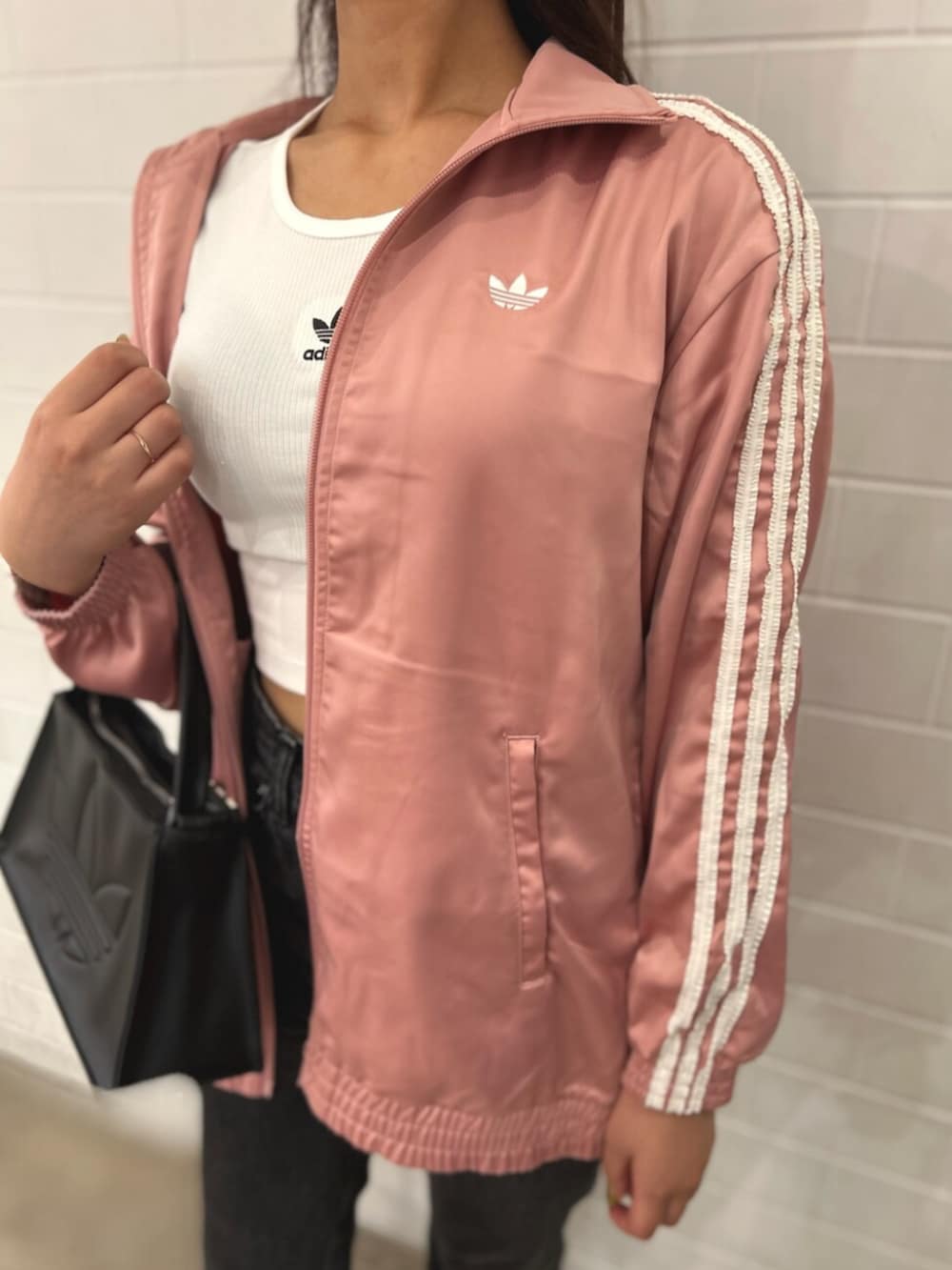 ピンク系のトップス、ホワイト系のTシャツ/カットソー、ブラック系のショルダーバッグを着用したレディースの夏コーディネートの2枚目の写真