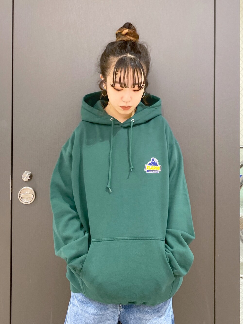 グリーン系のパーカー、ブルー系のその他パンツ、ブラック系のバックパック/リュックを着用したレディースの冬コーディネートの3枚目の写真