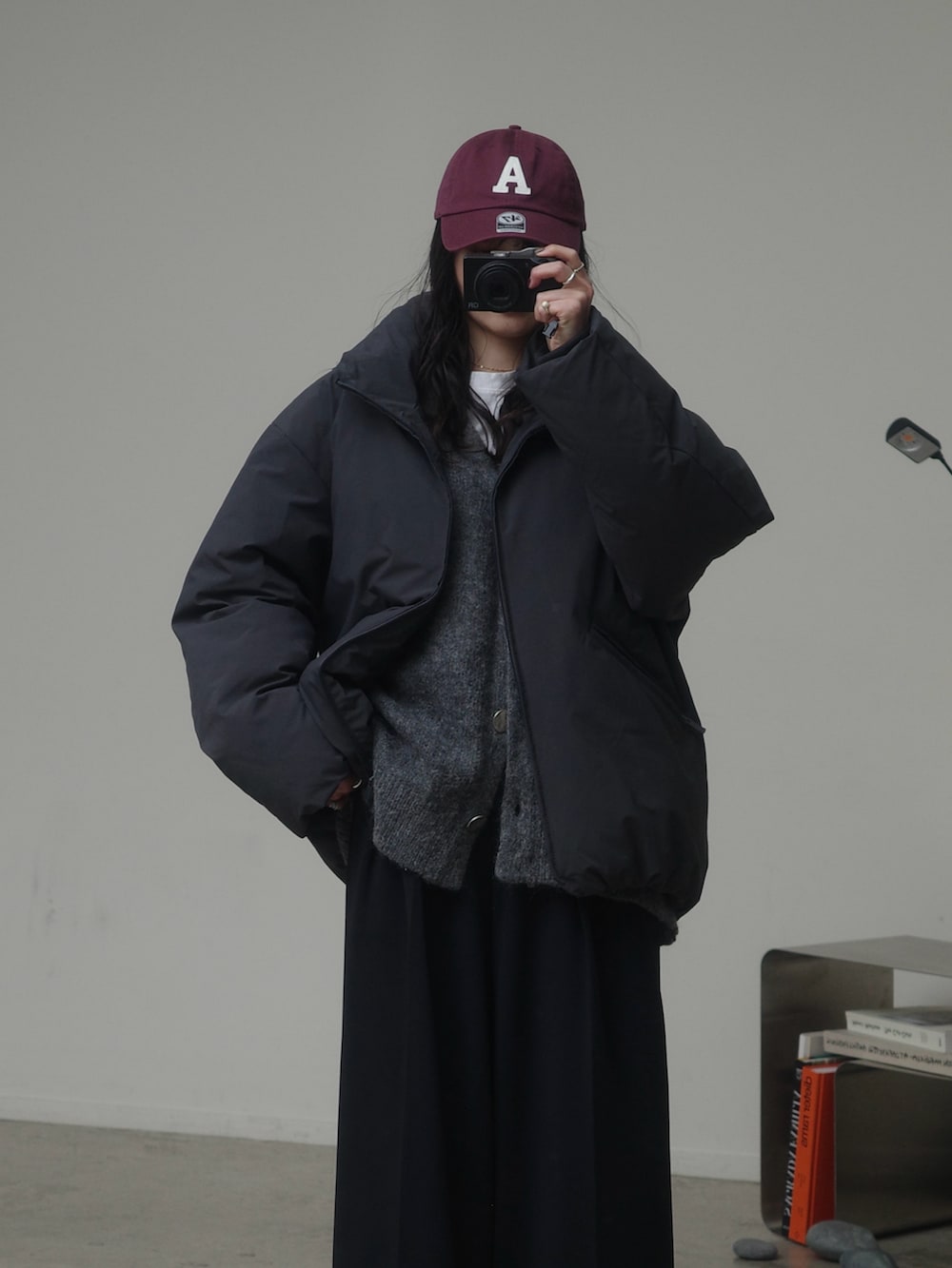 グレー系のダウンジャケット/コート、グレー系のカーディガン/ボレロ、ブラック系のその他パンツを着用したレディースの冬コーディネートの2枚目の写真