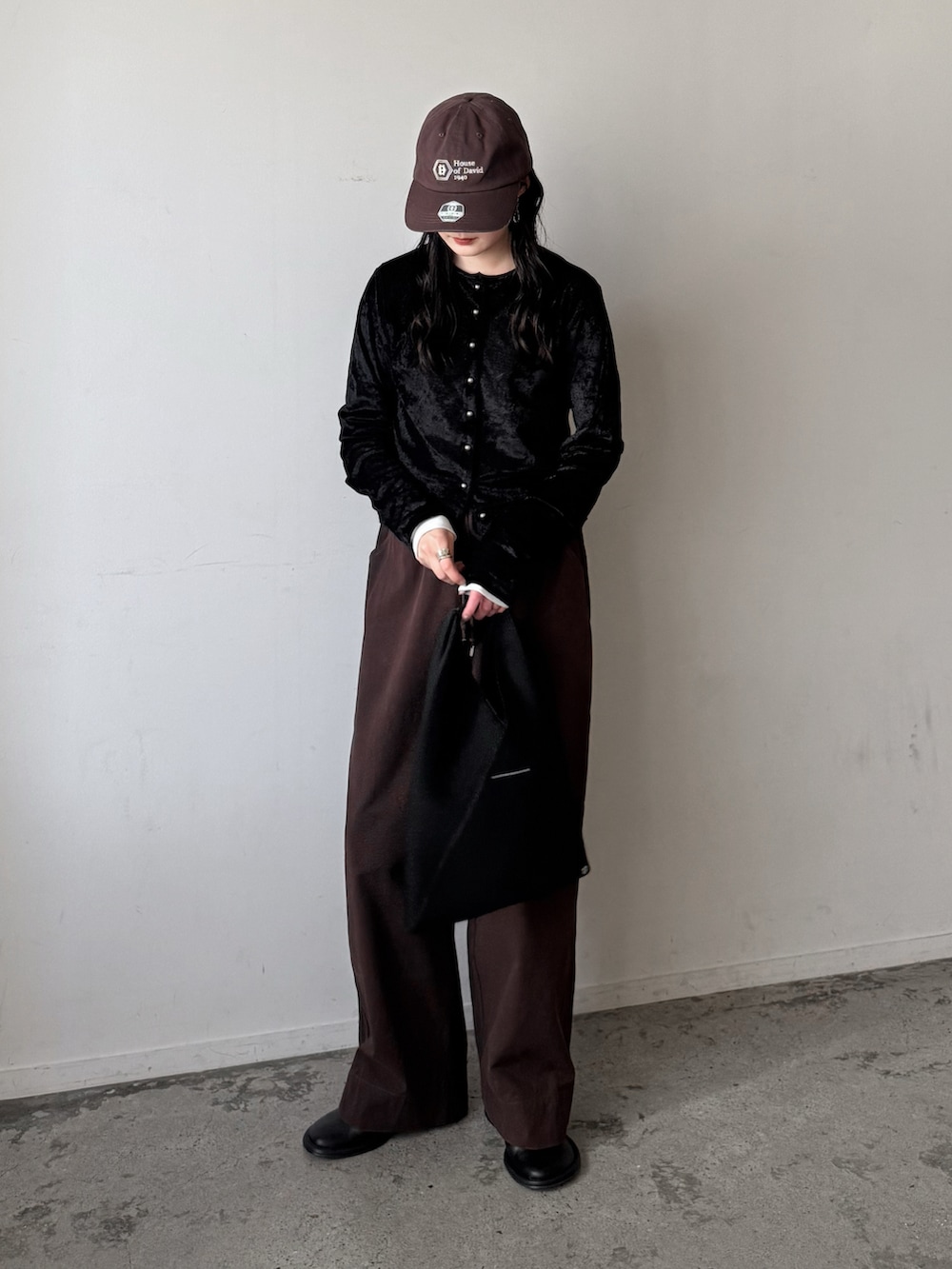 ブラック系のカーディガン/ボレロ、レッド系のチノパンツ、ブラック系のスリッポンを着用したレディースの冬コーディネートの2枚目の写真