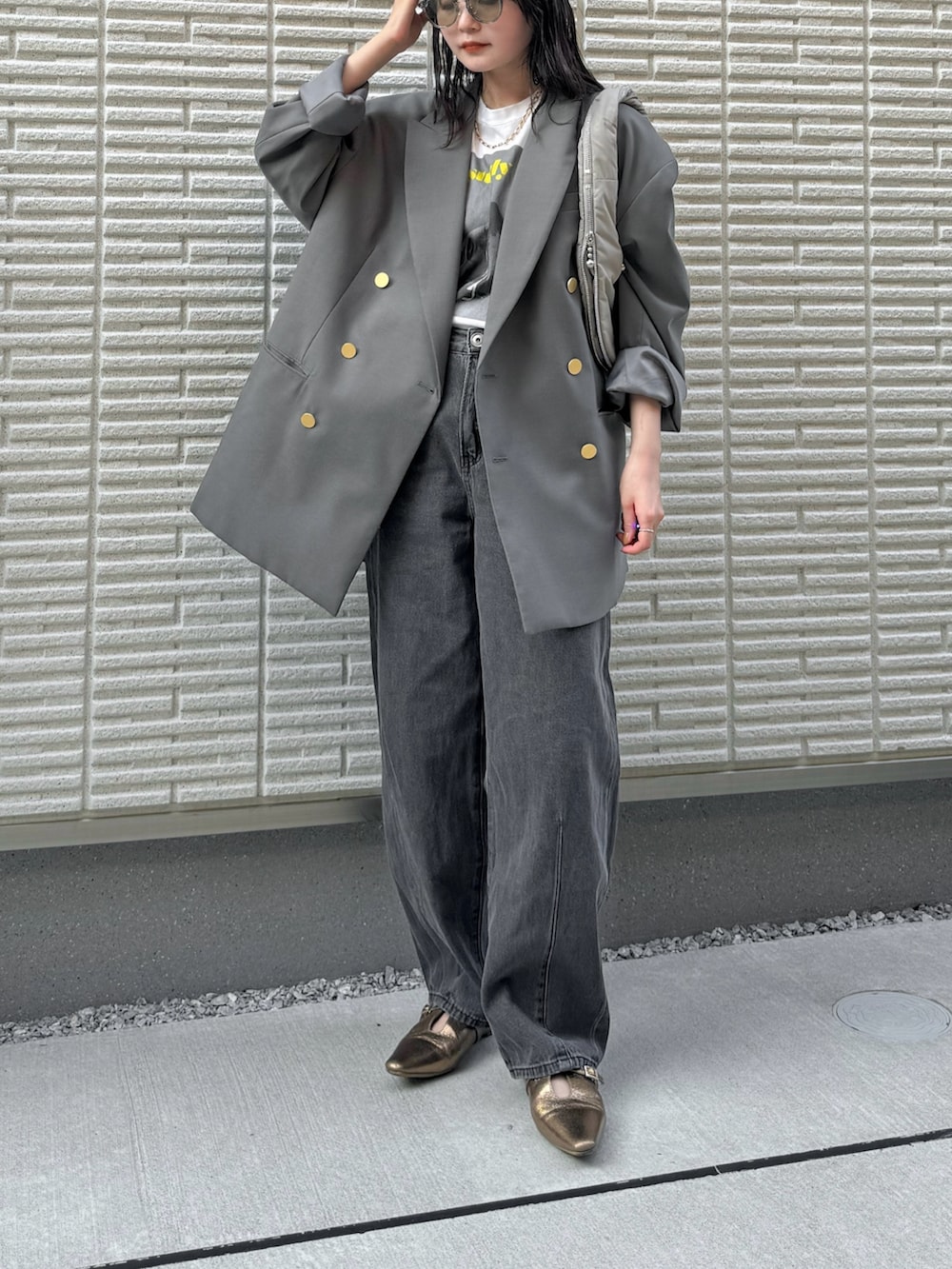 グレー系のテーラードジャケット、ホワイト系のTシャツ/カットソー、ブラック系のデニムパンツを着用したレディースの秋コーディネートの3枚目の写真