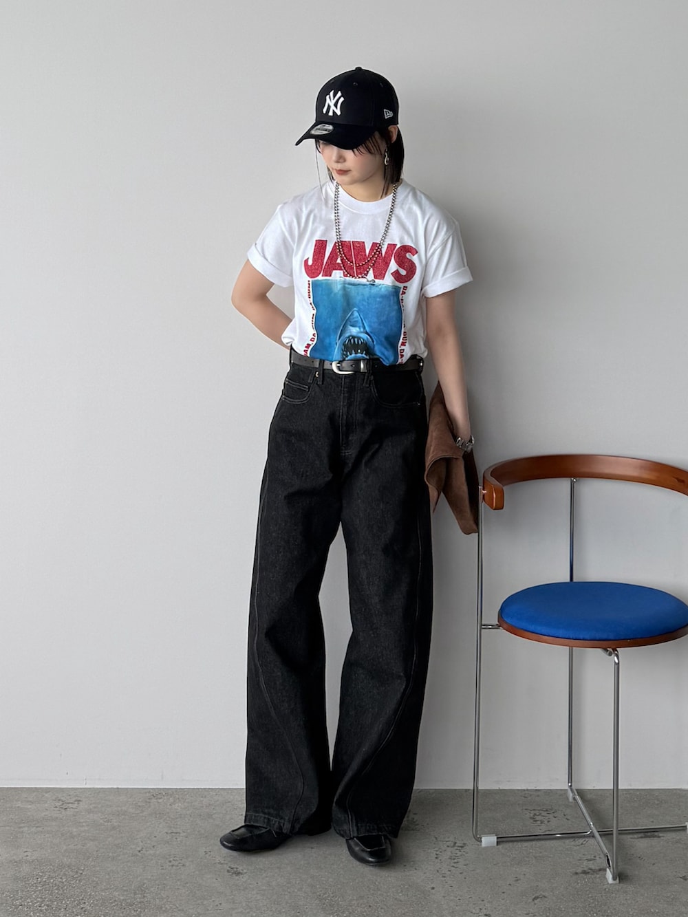 ホワイト系のTシャツ/カットソー、ブラック系のデニムパンツ、ブラウン系のトートバッグを着用したレディースの夏コーディネートの2枚目の写真