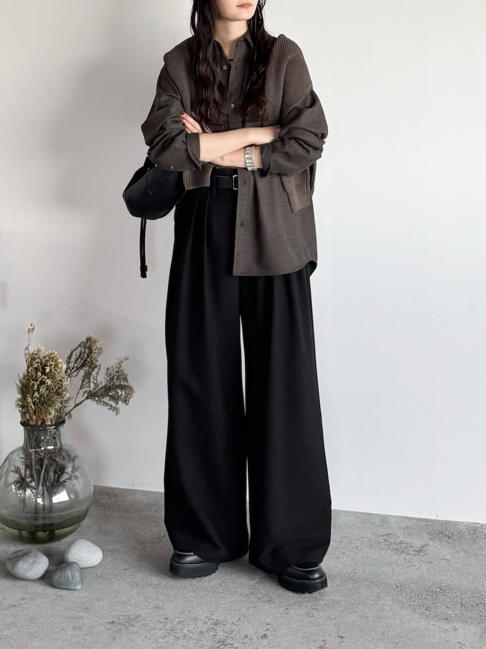 ブラウン系のシャツ/ブラウス、ブラウン系のニット/セーター、ブラック系のスラックスを着用したレディースの秋コーディネートの2枚目の写真