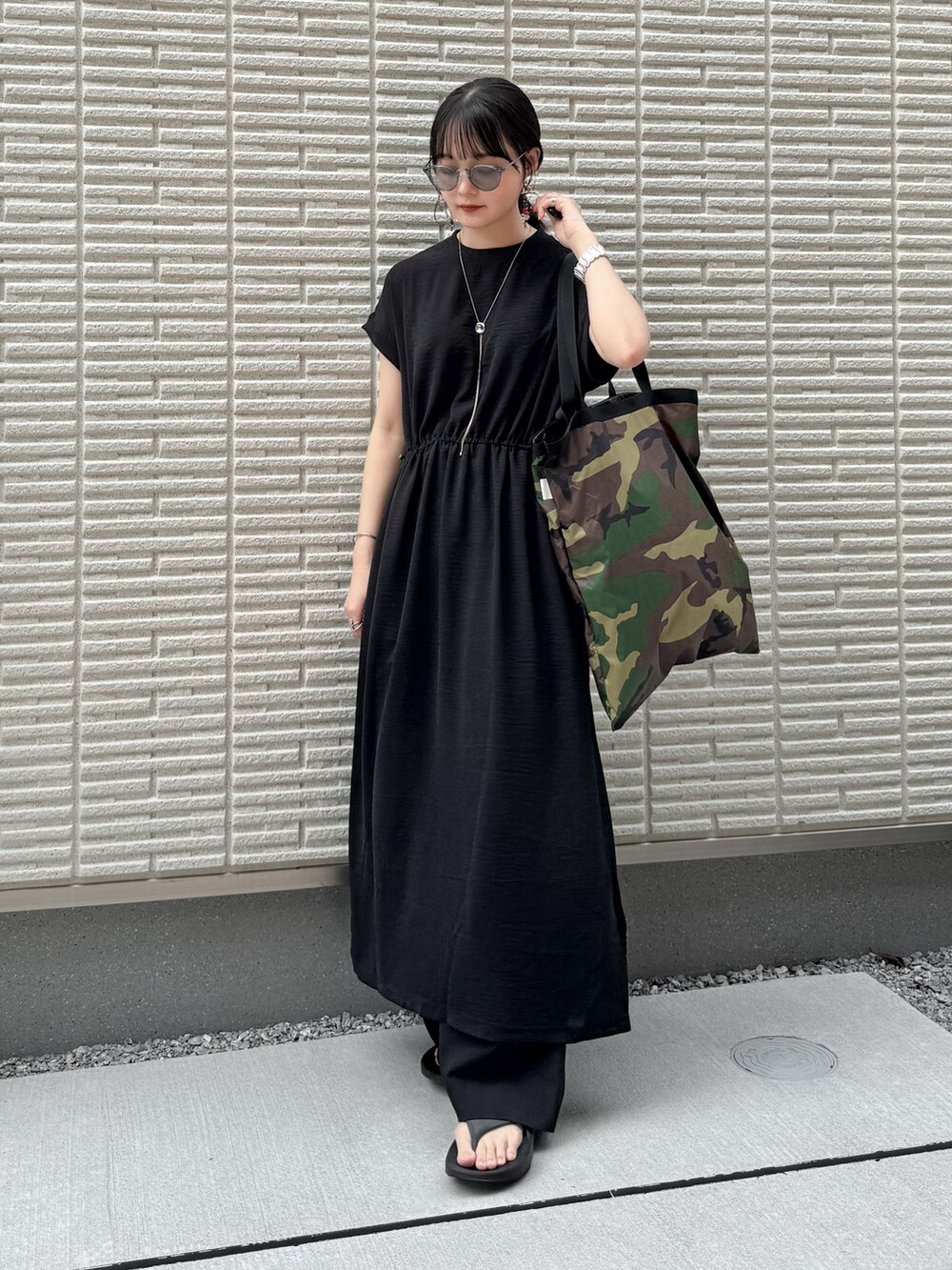 ブラック系のワンピース、ブラック系のその他パンツ、グリーン系のトートバッグを着用したレディースの夏コーディネートの2枚目の写真