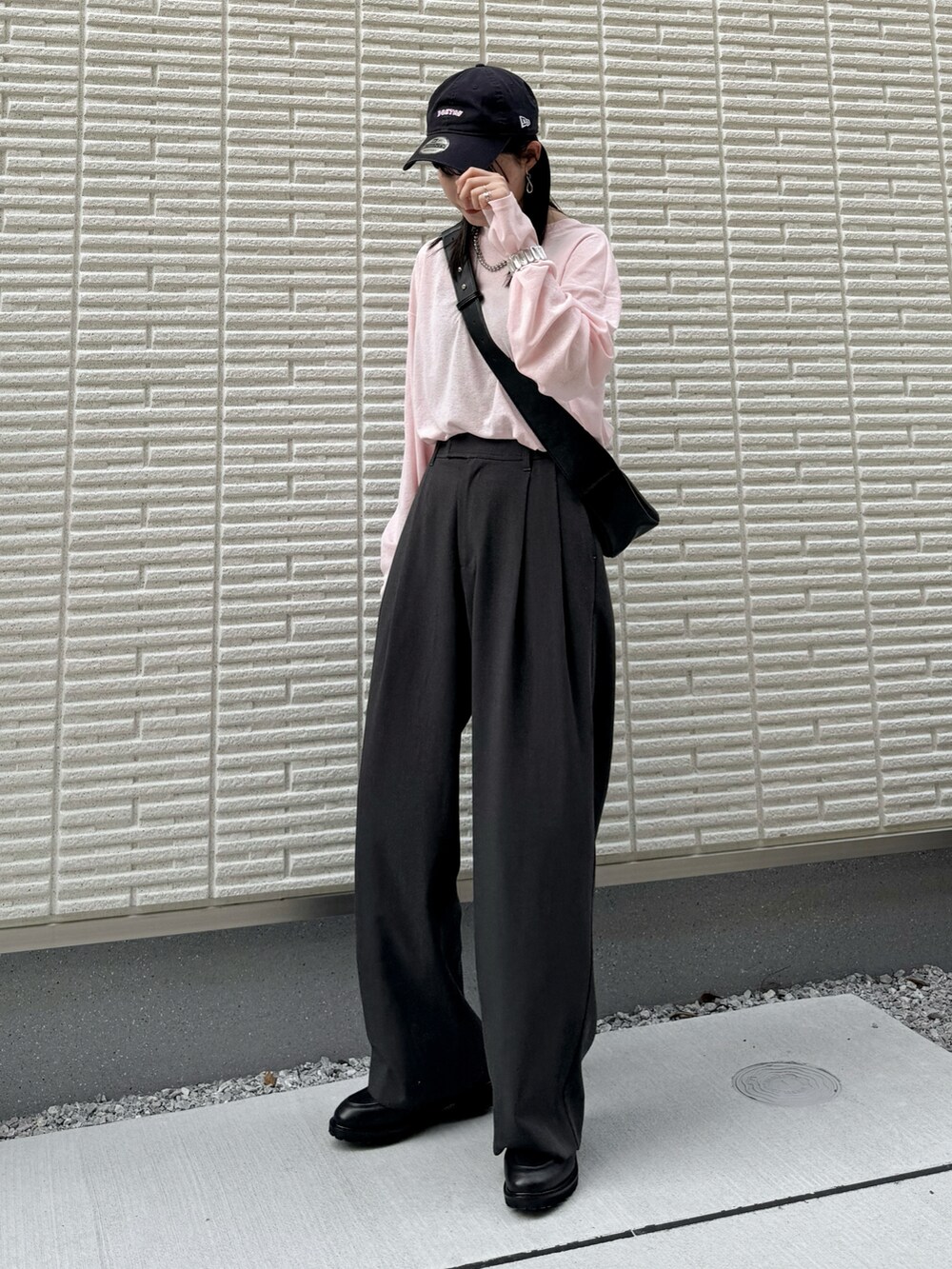ピンク系のTシャツ/カットソー、グレー系のその他パンツ、ブラック系のショルダーバッグを着用したレディースの春コーディネートの2枚目の写真