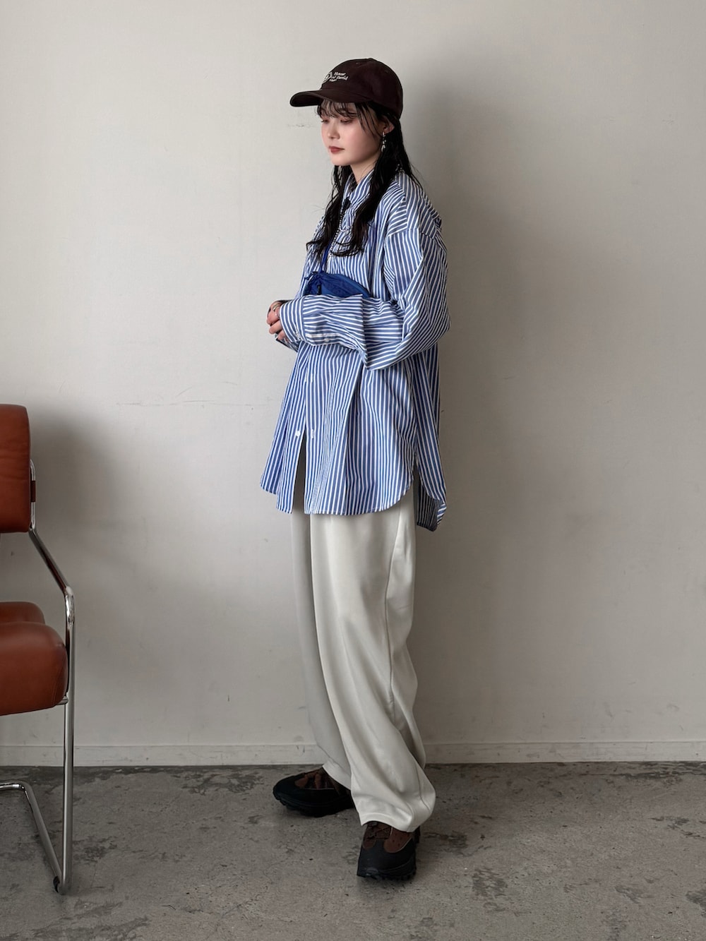 ブルー系のシャツ/ブラウス、ホワイト系のスウェットパンツ、ブルー系のボディバッグ/ウエストポーチを着用したレディースの春コーディネートの2枚目の写真