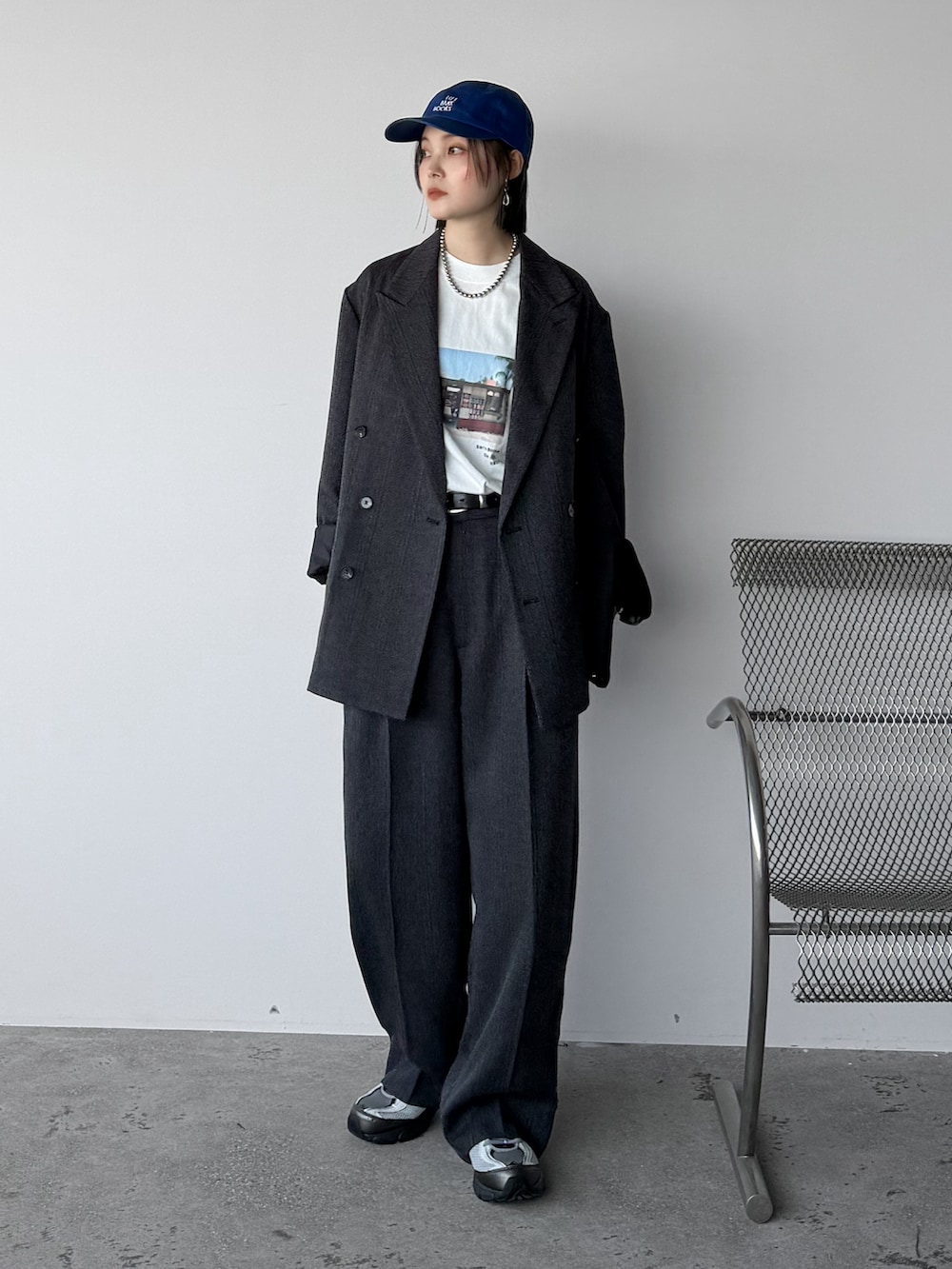 グレー系のスニーカー、ホワイト系のTシャツ/カットソー、グレー系のテーラードジャケットを着用したレディースの秋コーディネートの2枚目の写真