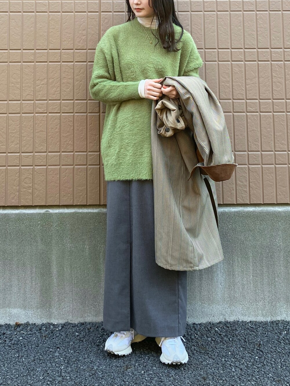 グリーン系のニット/セーター、ベージュ系のその他アウター、ベージュ系のワンピースを着用したレディースの冬コーディネートの3枚目の写真