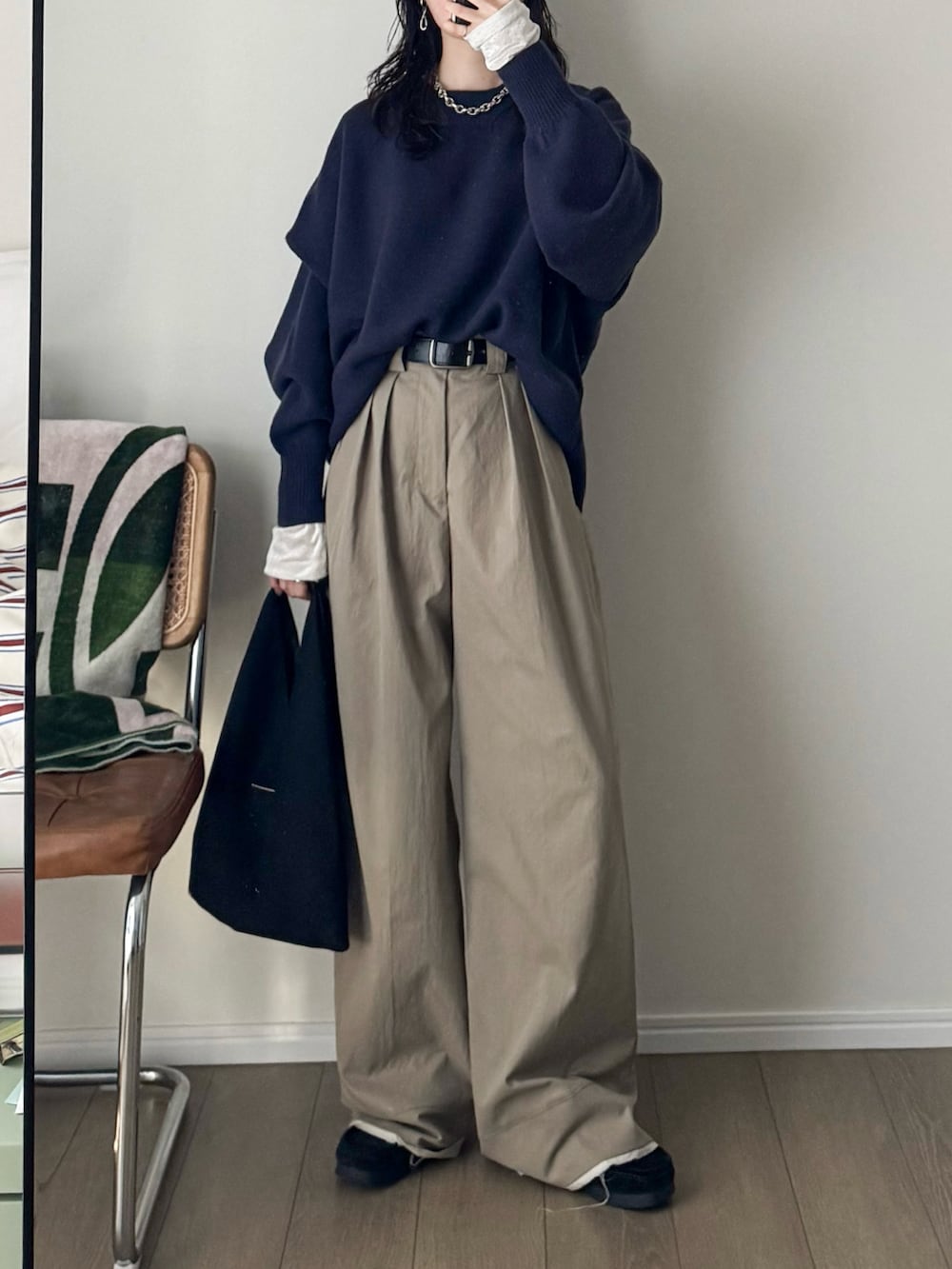 ブラック系のモカシン/デッキシューズ、ベージュ系のスラックス、ブルー系のニット/セーターを着用したレディースの秋コーディネートの2枚目の写真