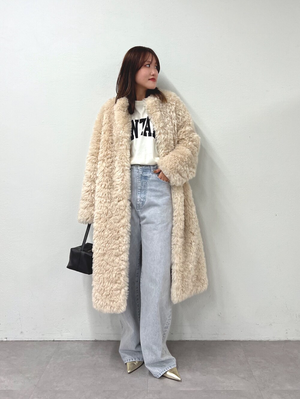 ホワイト系のTシャツ/カットソー、ホワイト系のその他アウター、グレー系のデニムパンツを着用したレディースの秋コーディネートの4枚目の写真