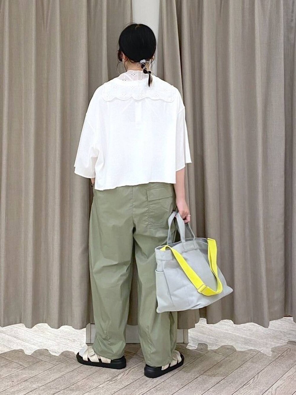 ベージュ系のサンダル、グリーン系のTシャツ/カットソー、グレー系のトートバッグを着用したレディースの夏コーディネートの3枚目の写真