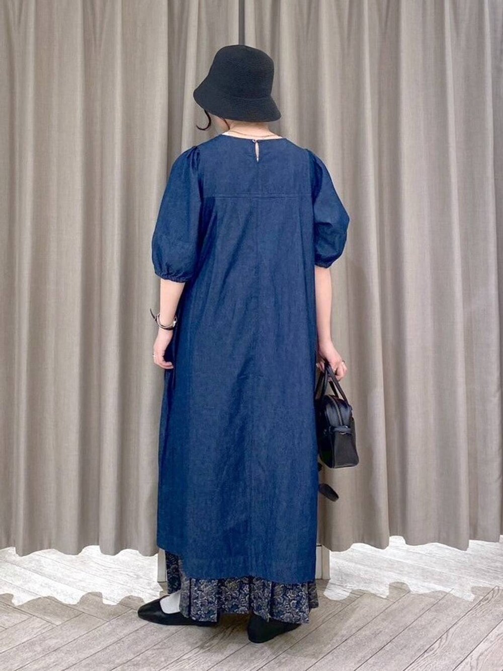 ブラック系のショルダーバッグ、ホワイト系のタンクトップ、ブルー系のワンピースを着用したレディースの夏コーディネートの6枚目の写真