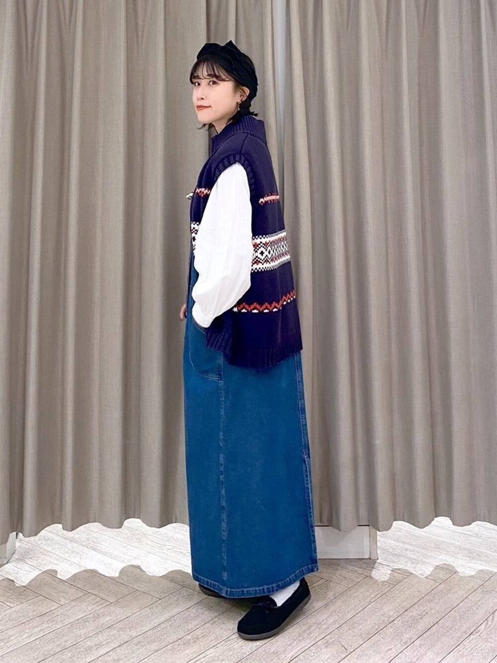 ブラック系のショルダーバッグ、ブルー系のワンピース、ブラック系のヘアバンドを着用したレディースの秋コーディネートの5枚目の写真