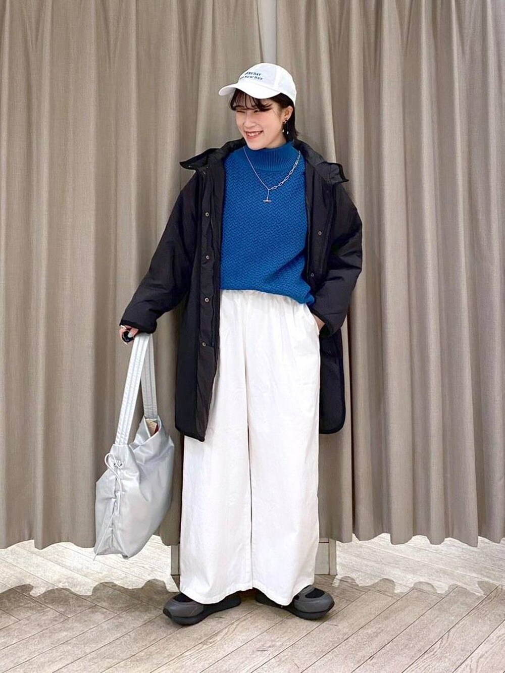 ブラック系のスニーカー、ブラック系のダウンジャケット/コート、その他のショルダーバッグを着用したレディースの冬コーディネートの8枚目の写真