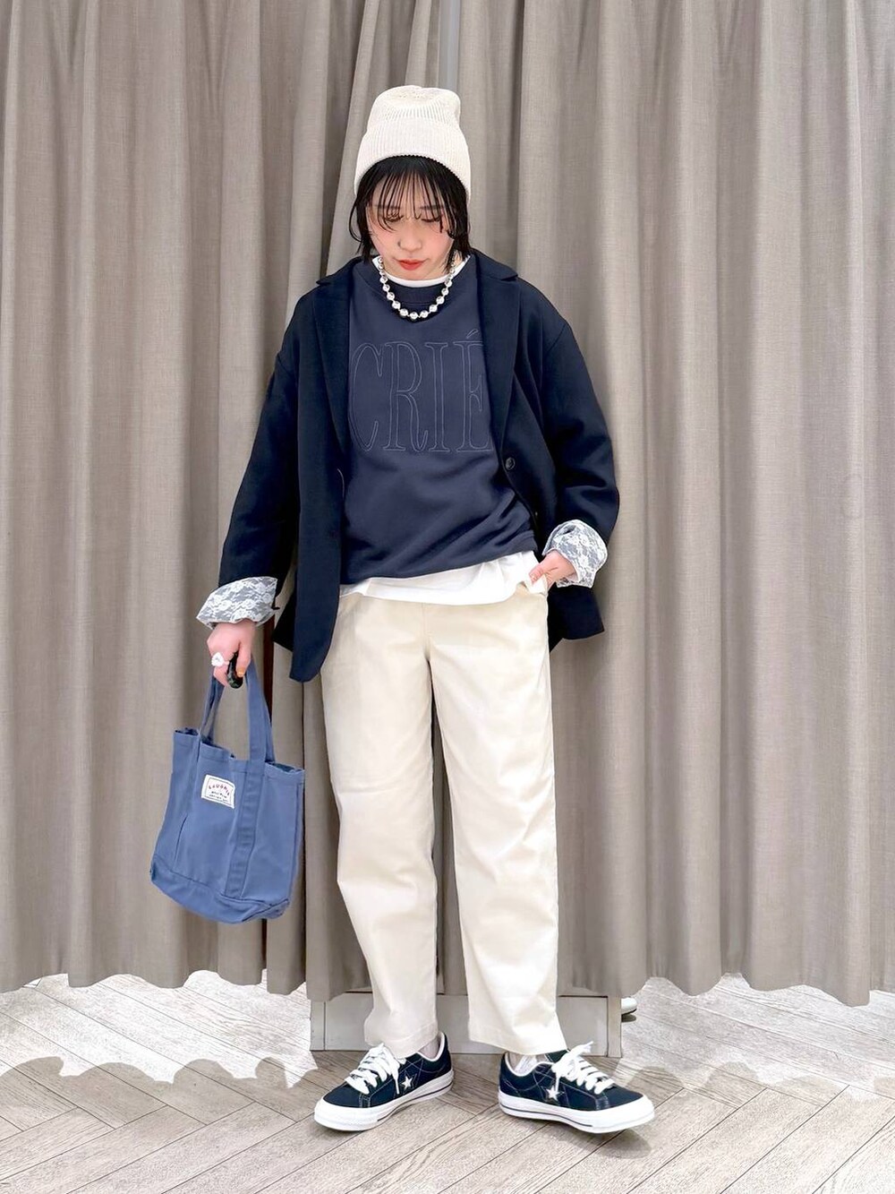 ブルー系のトートバッグ、ブルー系のスニーカー、ベージュ系のその他パンツを着用したレディースの春コーディネートの9枚目の写真