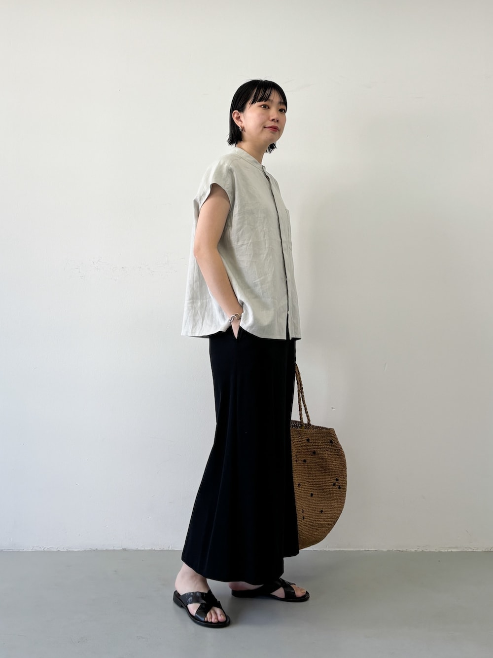 グレー系のTシャツ/カットソー、ブラック系のスカートを着用したレディースの夏コーディネートの2枚目の写真