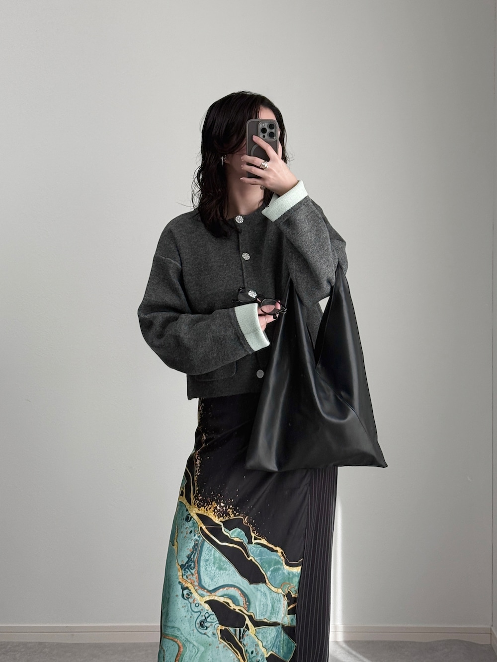 グレー系のカーディガン/ボレロ、ブラック系のスラックス、ブラック系のトートバッグを着用したレディースの秋コーディネートの3枚目の写真