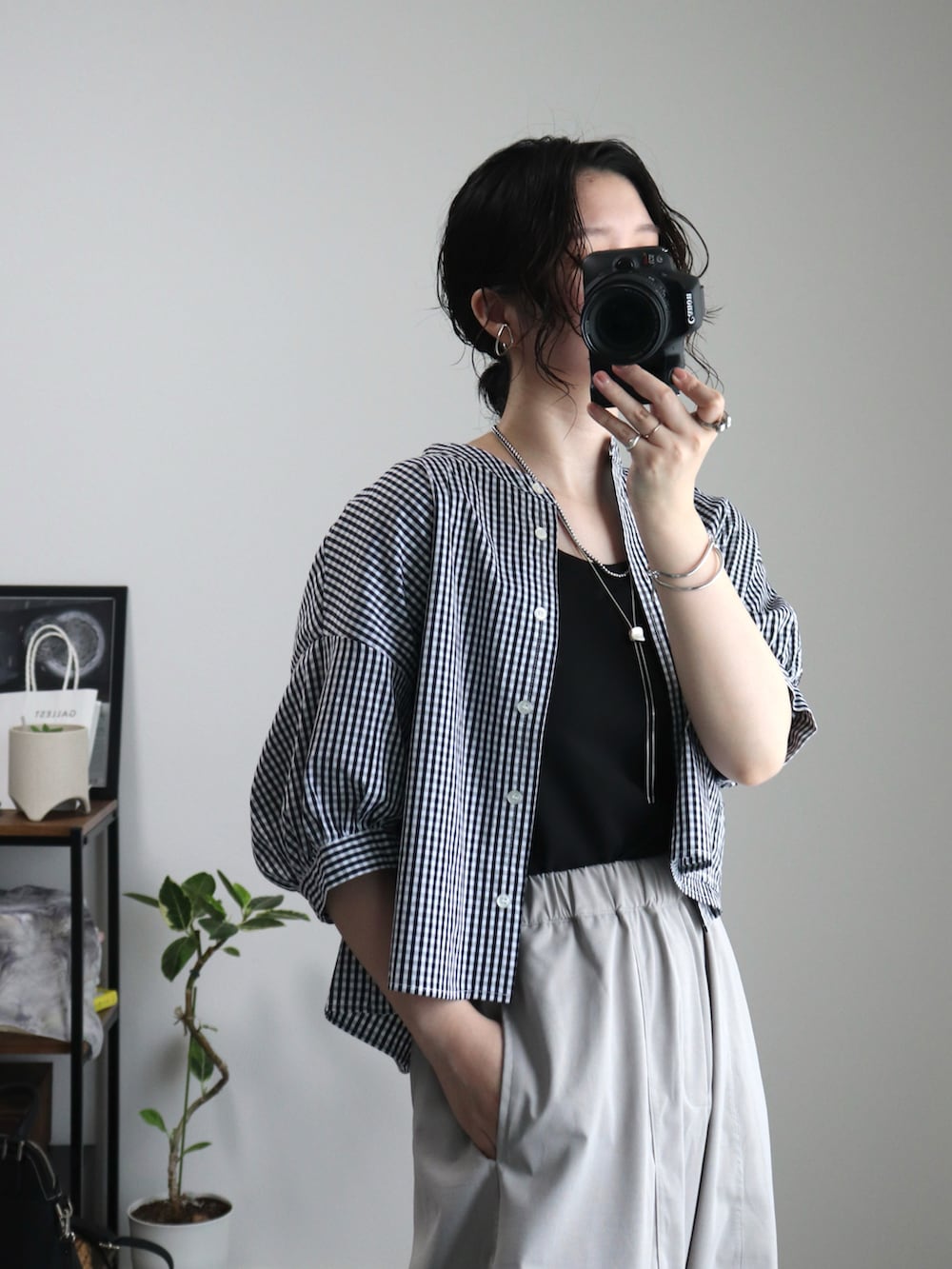 ブラック系のシャツ/ブラウス、ブラック系のショルダーバッグ、ブラック系のサンダルを着用したレディースの夏コーディネートの3枚目の写真