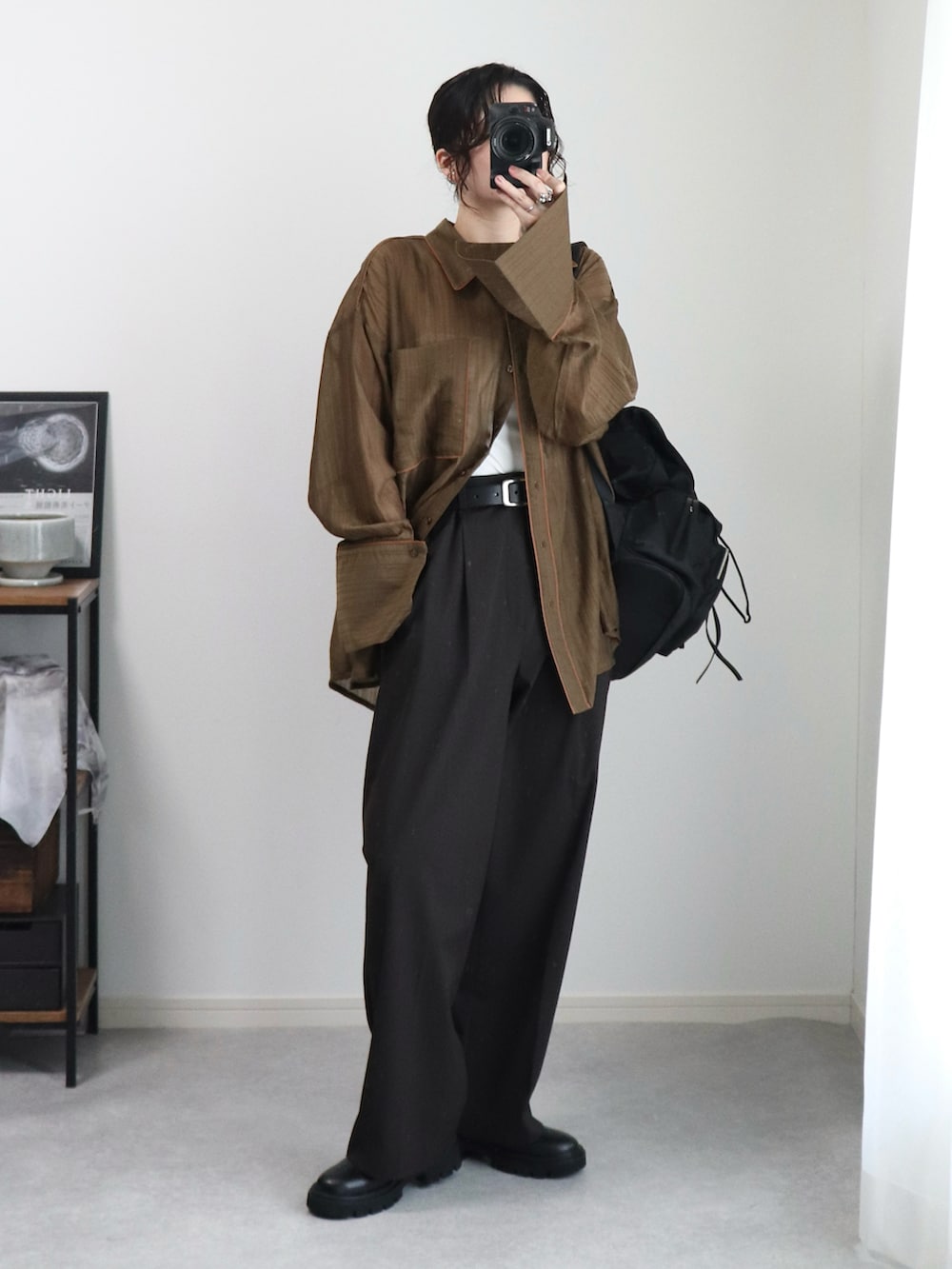 ブラック系のブーツ、ブラウン系のシャツ/ブラウス、ブラック系のバックパック/リュックを着用したレディースの夏コーディネートの2枚目の写真