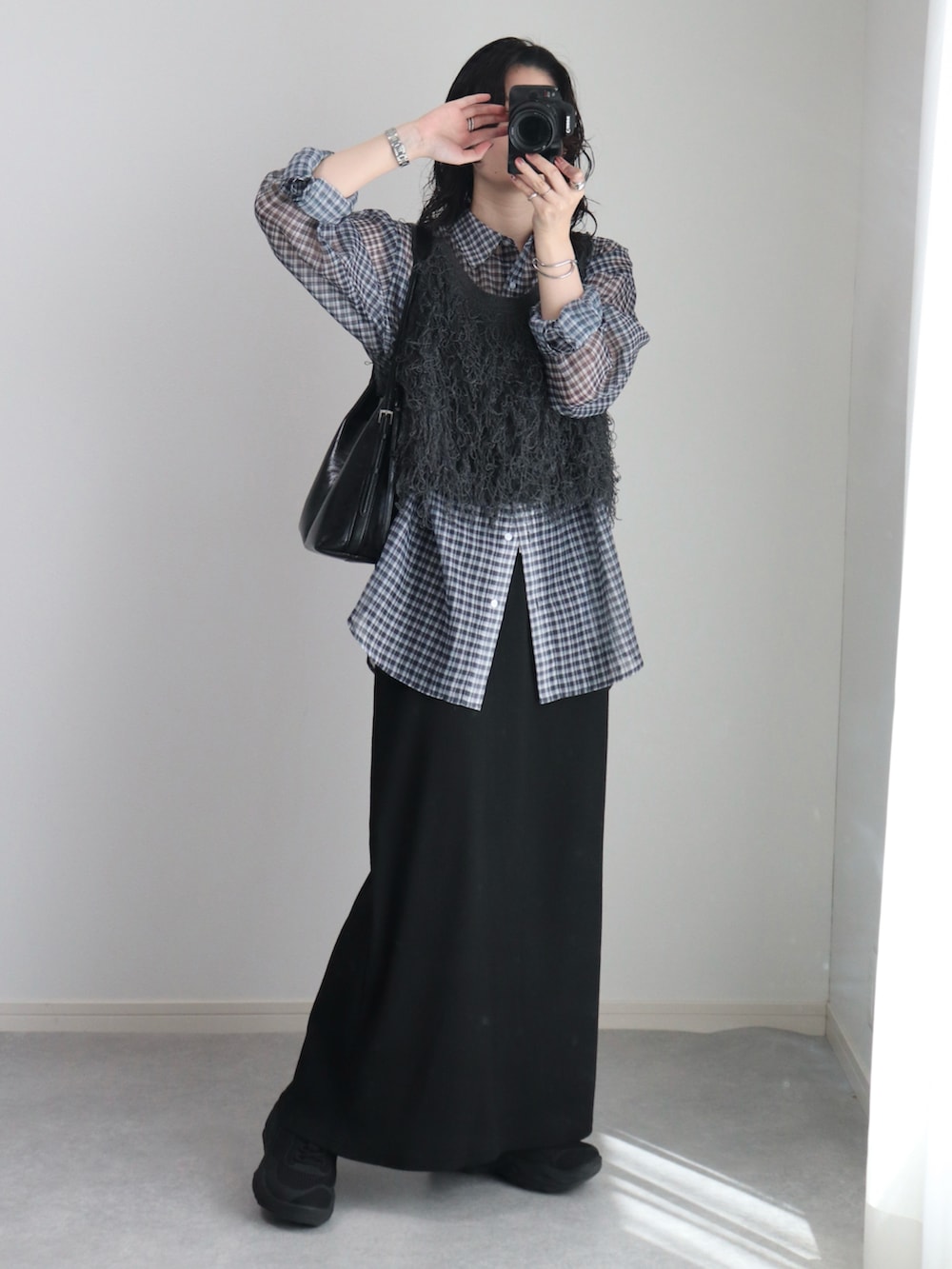 グレー系のベスト、ブラック系のシャツ/ブラウス、ブラック系のスカートを着用したレディースの秋コーディネートの4枚目の写真