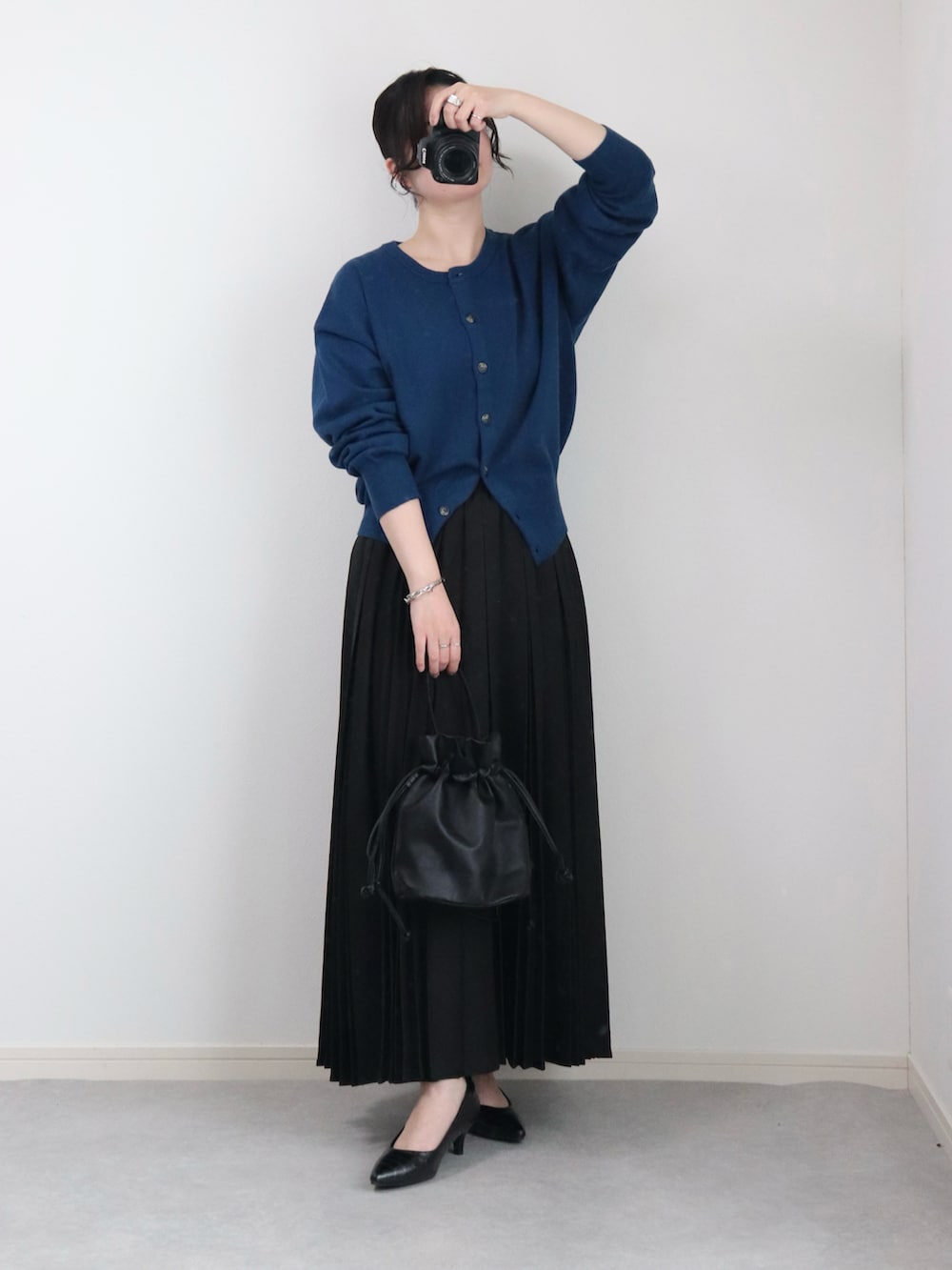 ブルー系のカーディガン/ボレロ、ブラック系のデニムジャケット、ブラック系のスカートを着用したレディースの春コーディネートの2枚目の写真