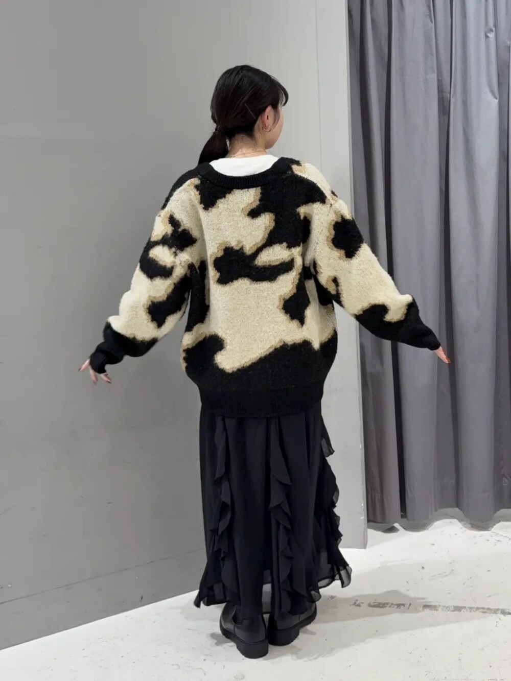 ベージュ系のカーディガン/ボレロ、ホワイト系のTシャツ/カットソー、ブラック系のスカートを着用したレディースの秋コーディネートの3枚目の写真