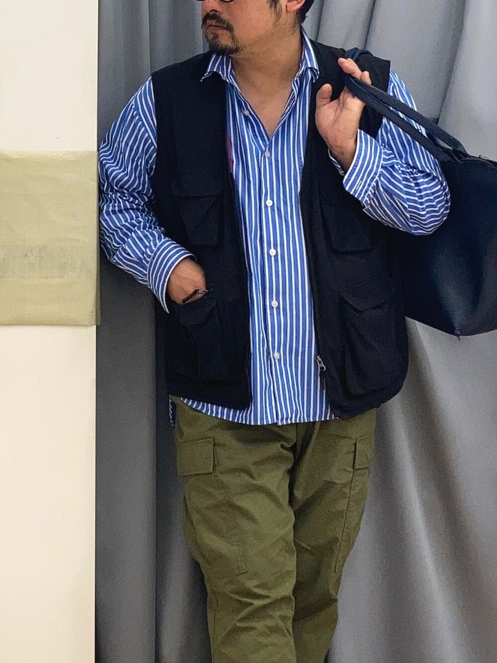 グリーン系のカーゴパンツ、ブラック系のサンダル、ブルー系のシャツ/ブラウスを着用したメンズの春コーディネートの2枚目の写真