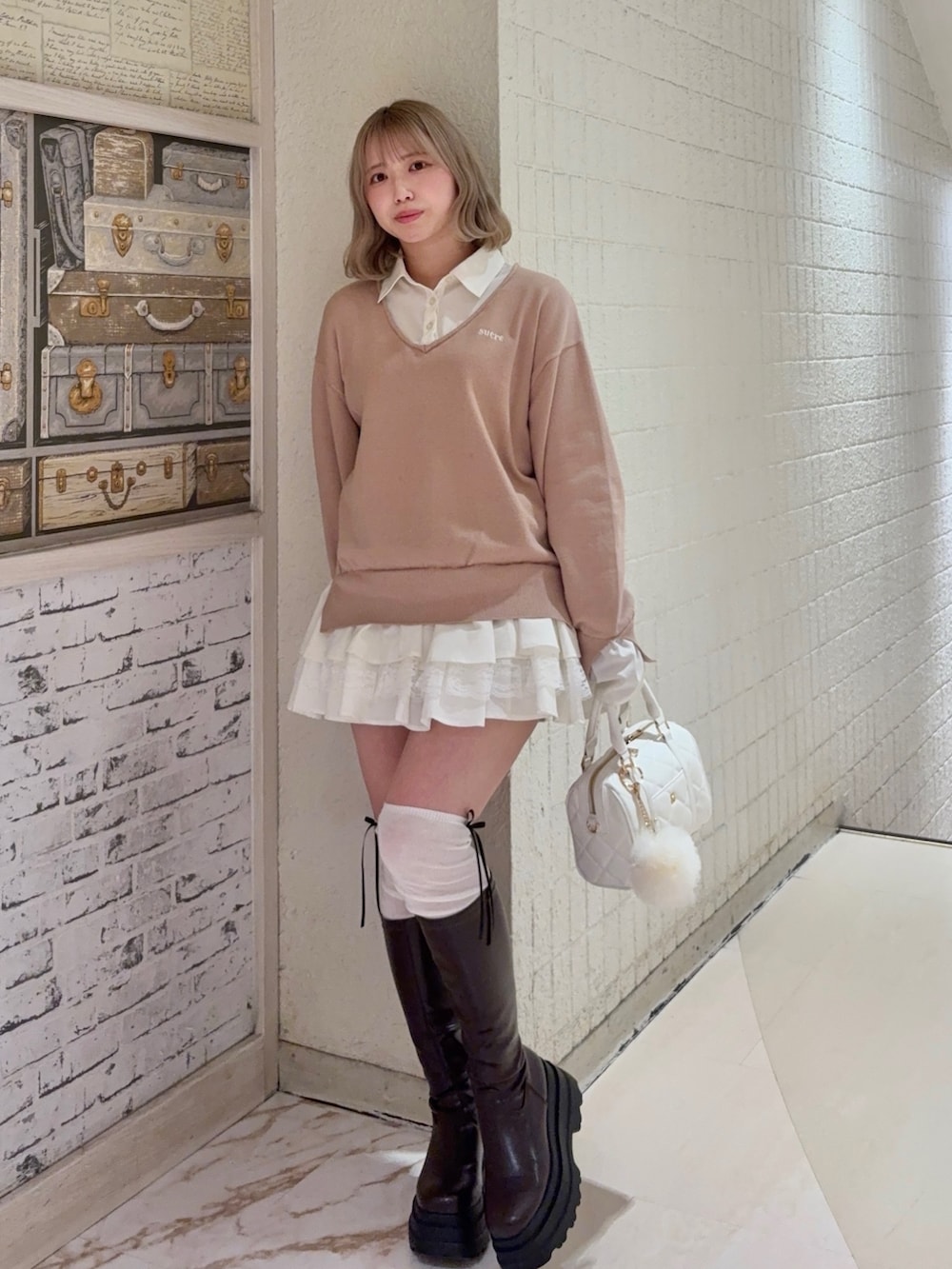 ベージュ系のワンピース、ホワイト系のボストンバッグを着用したレディースの冬コーディネートの2枚目の写真