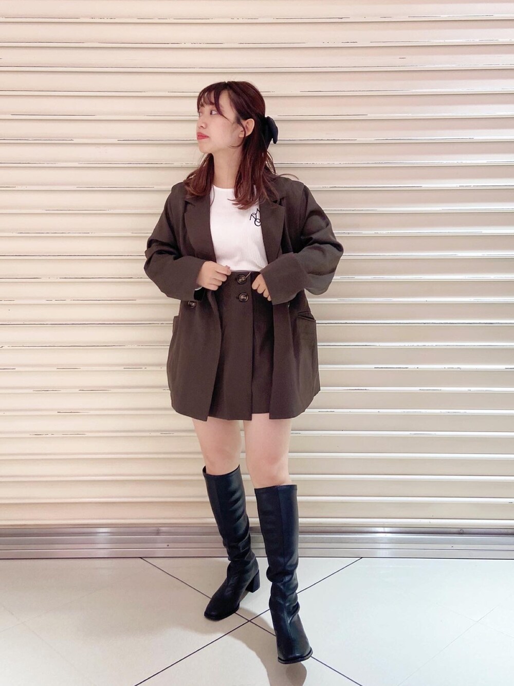 ブラウン系のテーラードジャケット、ホワイト系のTシャツ/カットソー、ブラウン系のその他パンツを着用したレディースの秋コーディネートの2枚目の写真