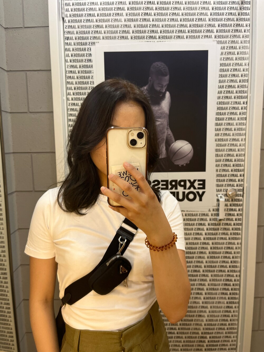 グリーン系のパンツ、ブラック系のバッグ、ホワイト系のTシャツ/カットソーを着用したレディースの春コーディネートの2枚目の写真