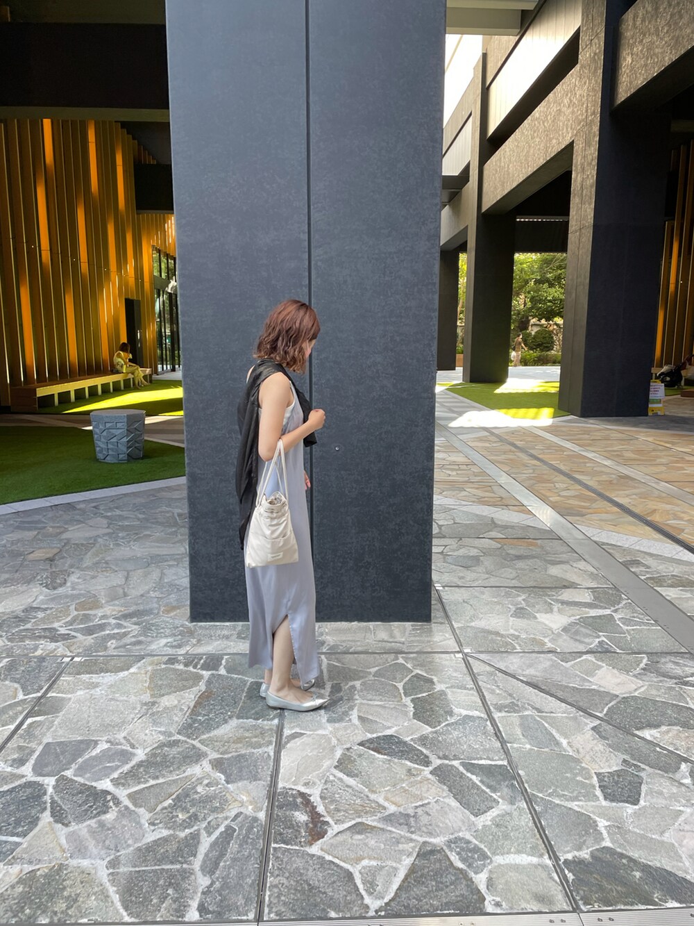 シルバー系のパンプス、ブラック系のシャツ/ブラウス、ホワイト系のトートバッグを着用したレディースの春コーディネートの2枚目の写真