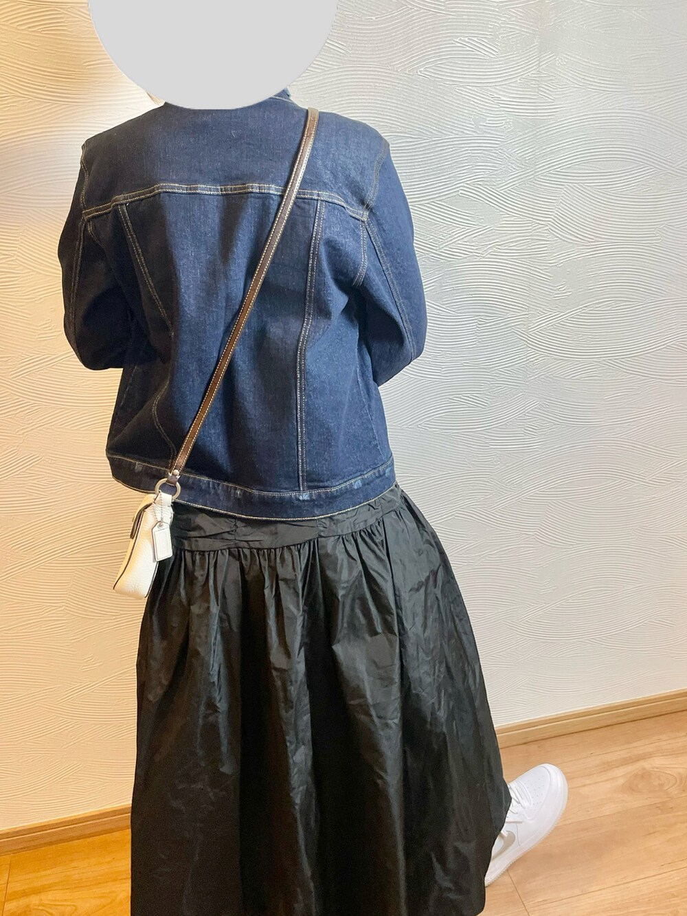 ホワイト系のニット/セーター、ブルー系のデニムジャケット、ホワイト系のスニーカーを着用したレディースの春コーディネートの4枚目の写真