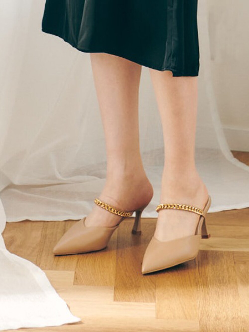 ブラック系のワンピース、ベージュ系のパンプス、ブラック系のその他トップスを着用したレディースの春コーディネートの3枚目の写真